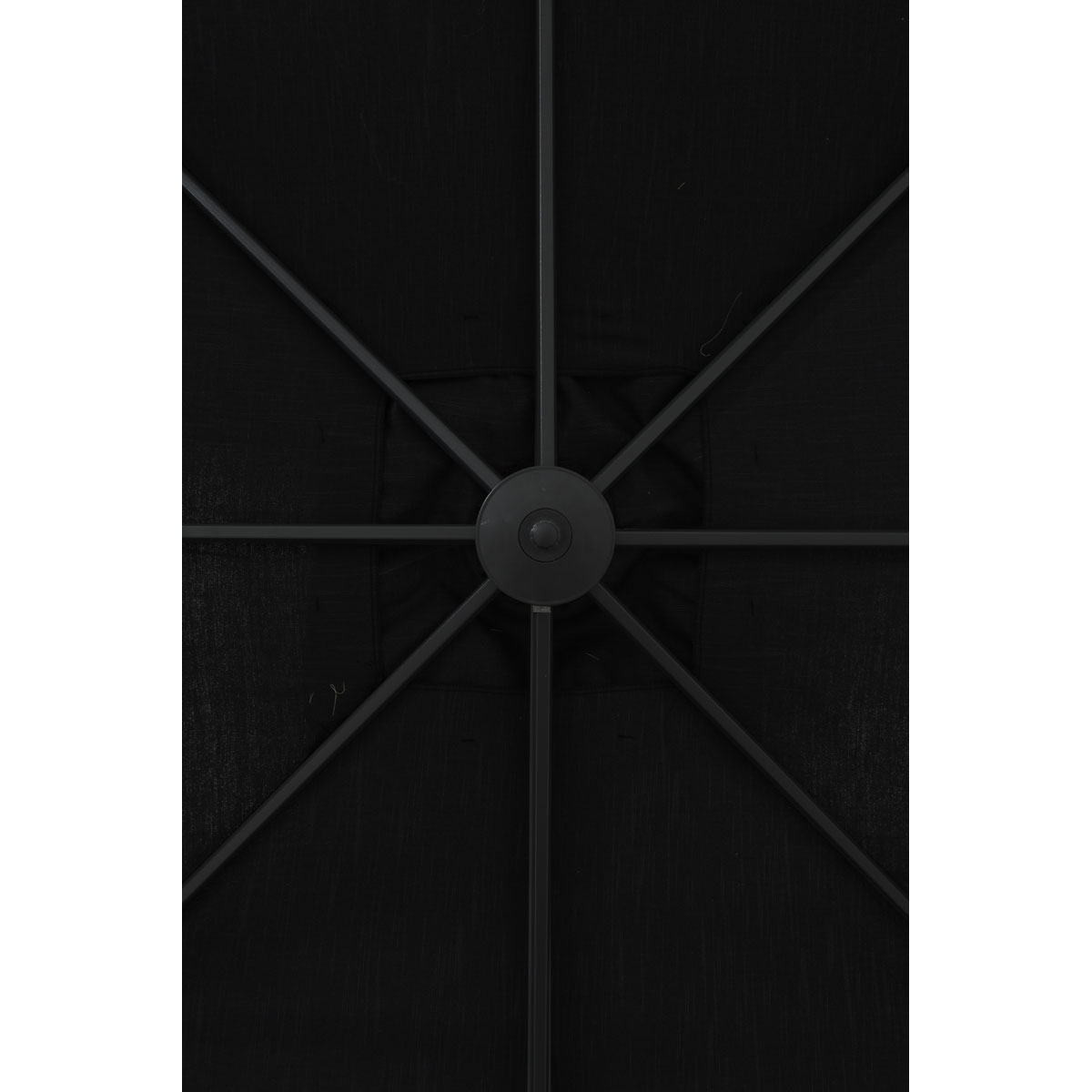 View from below of a black umbrella top, showing the central hub and supporting ribs.