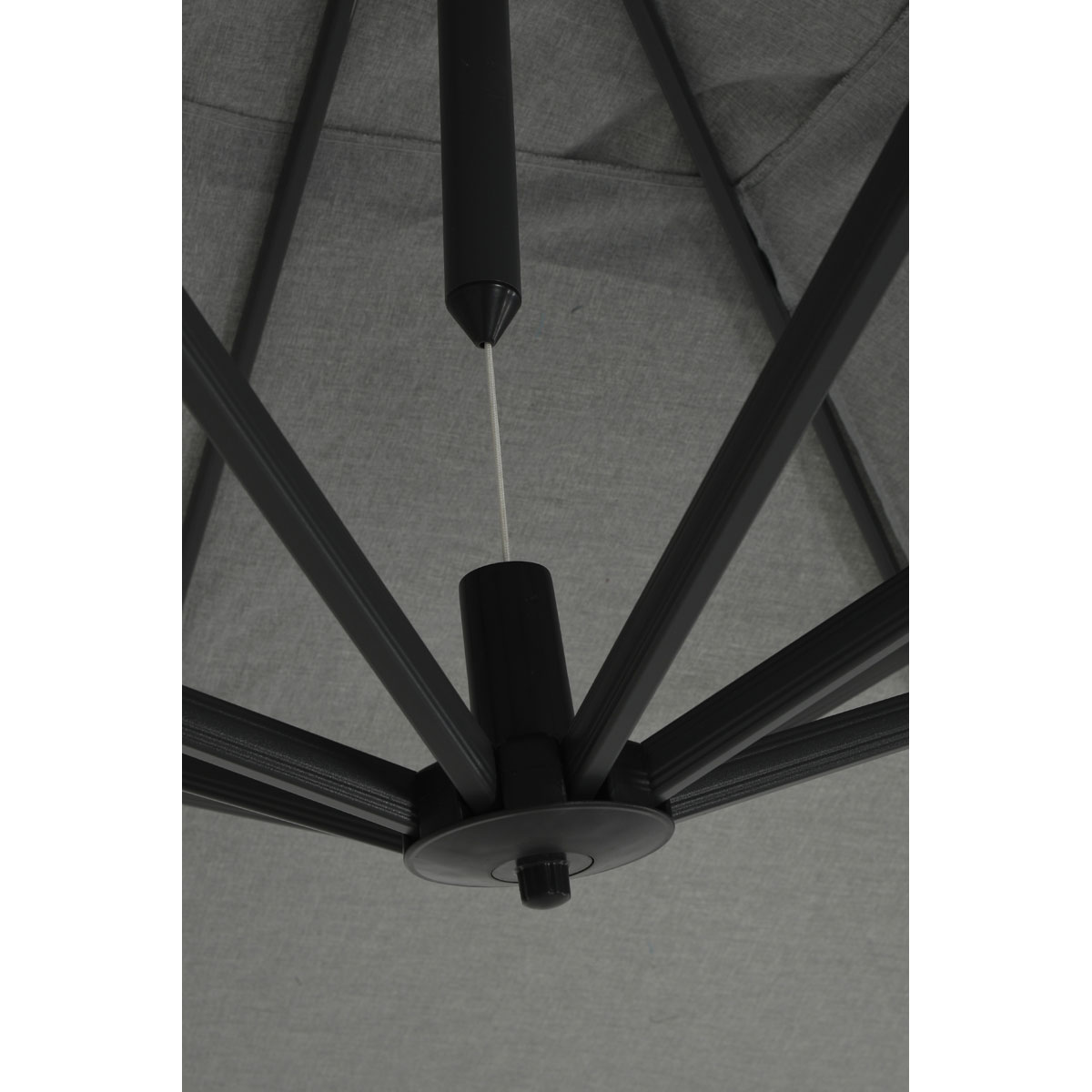 Close-up view from underneath a gray umbrella, showing the frame and fabric.