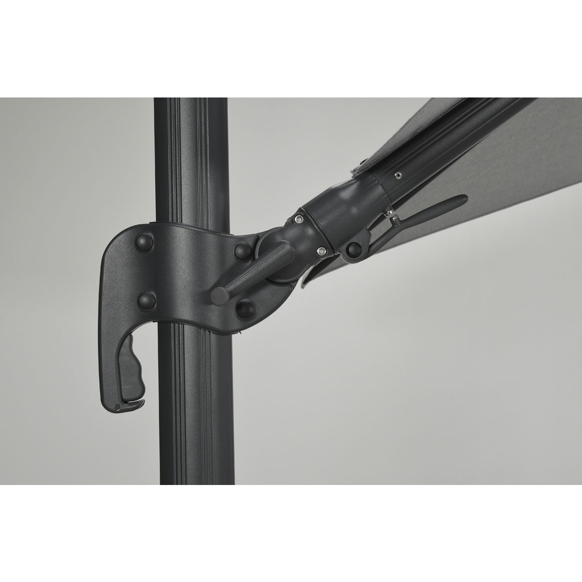 Close-up of the tilt mechanism on a black umbrella frame.