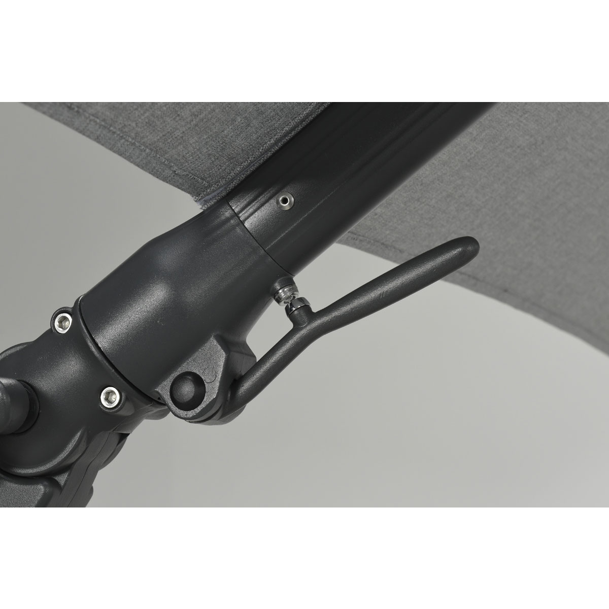 Close-up of the tilt mechanism on a black umbrella, showing the handle.