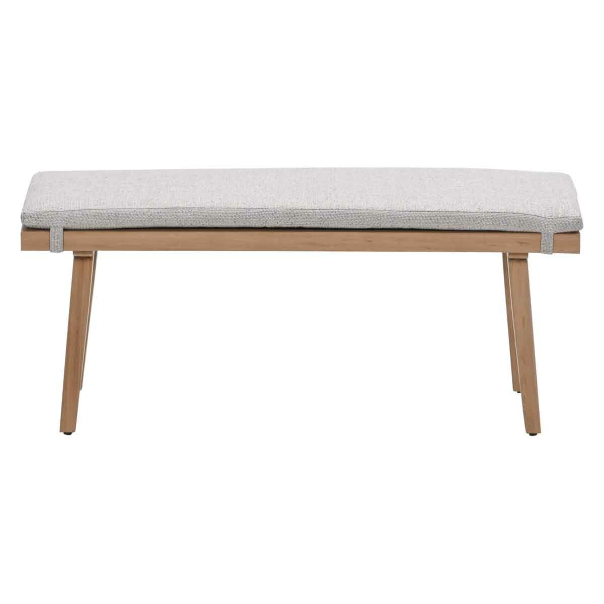 Wooden bench with light gray cushion. Four wooden legs support the bench.