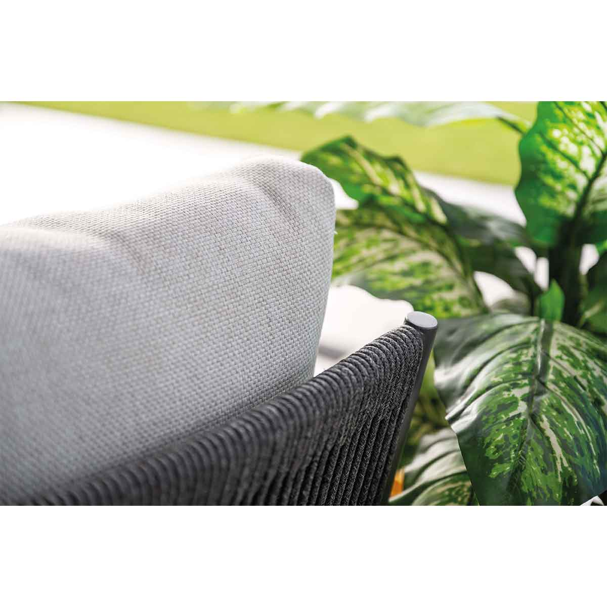 Close-up of a gray cushion and a pillow on a sofa.