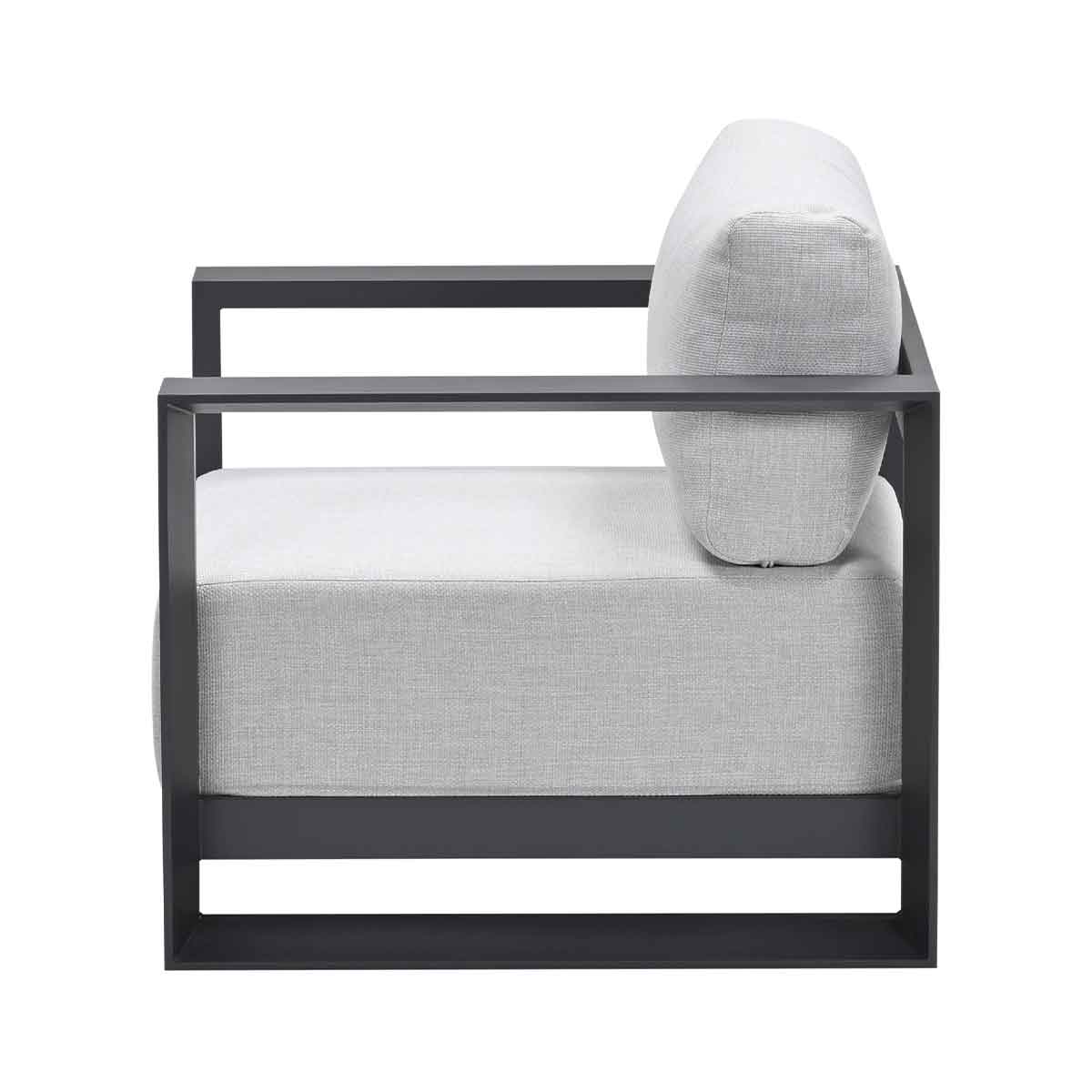Modern gray armchair, side view. Gray cushion and black frame.