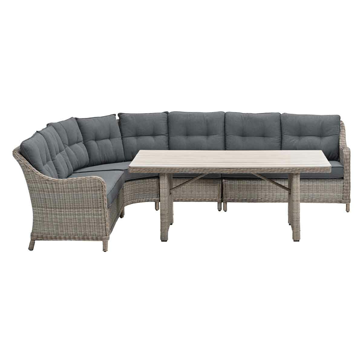 Outdoor wicker sectional sofa and table set with gray cushions. Light brown wicker frame. White background.