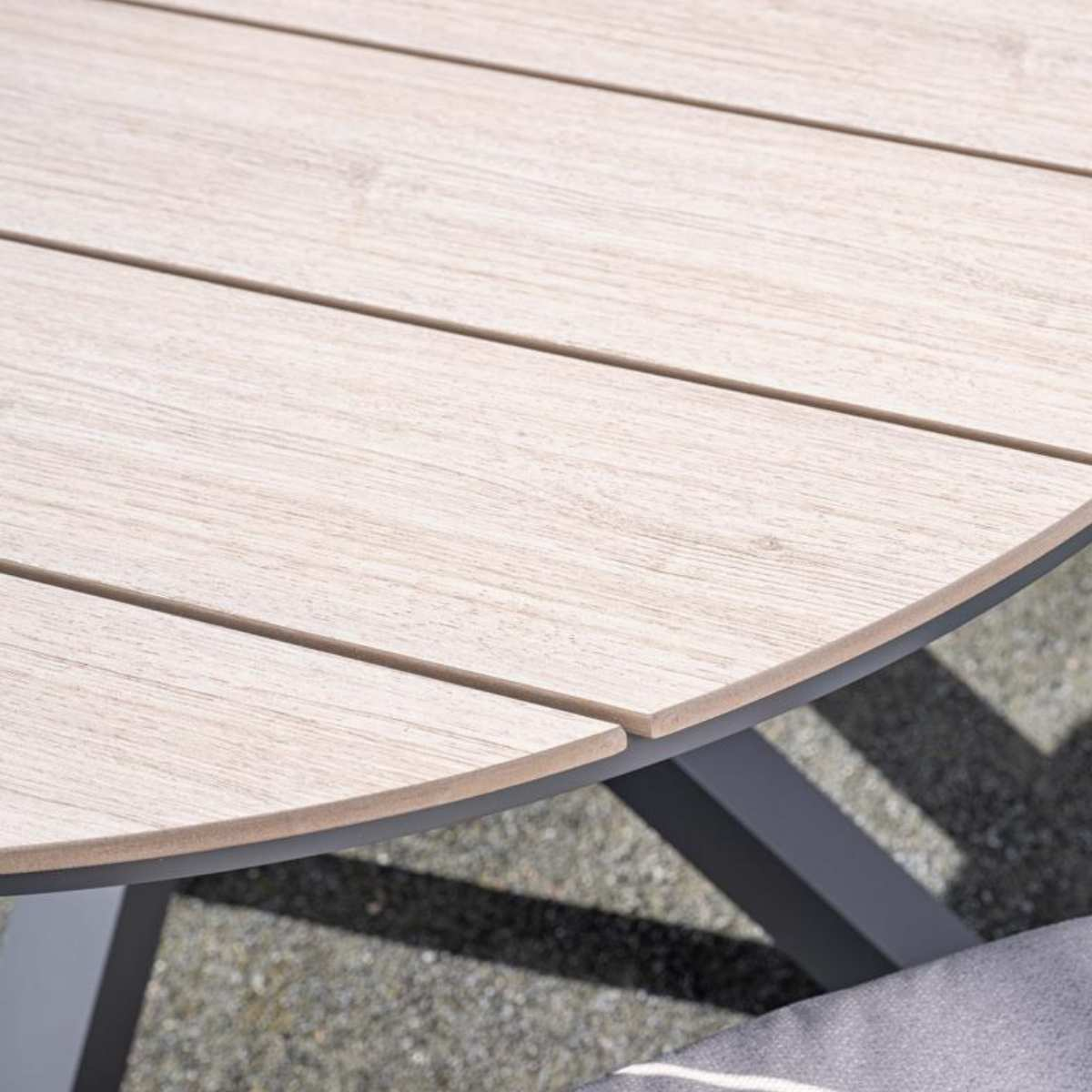 Gros plan sur la surface de la table en bois, avec le grain visible.