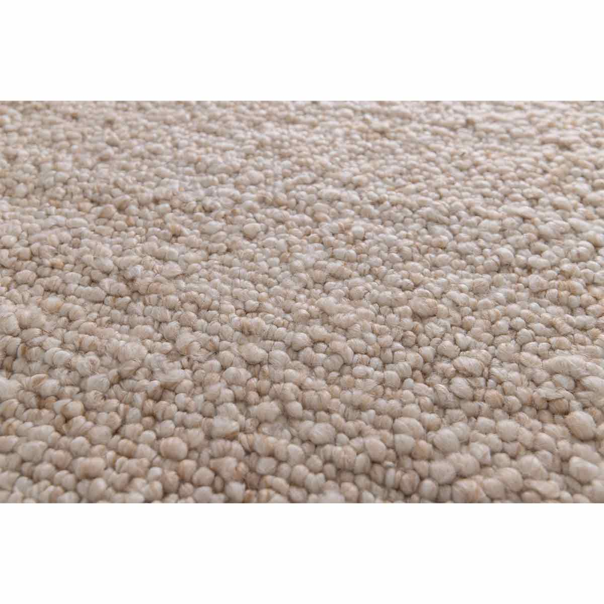 Close-up van een beige tapijt met getextureerde, afgeronde, kleine bobbels.