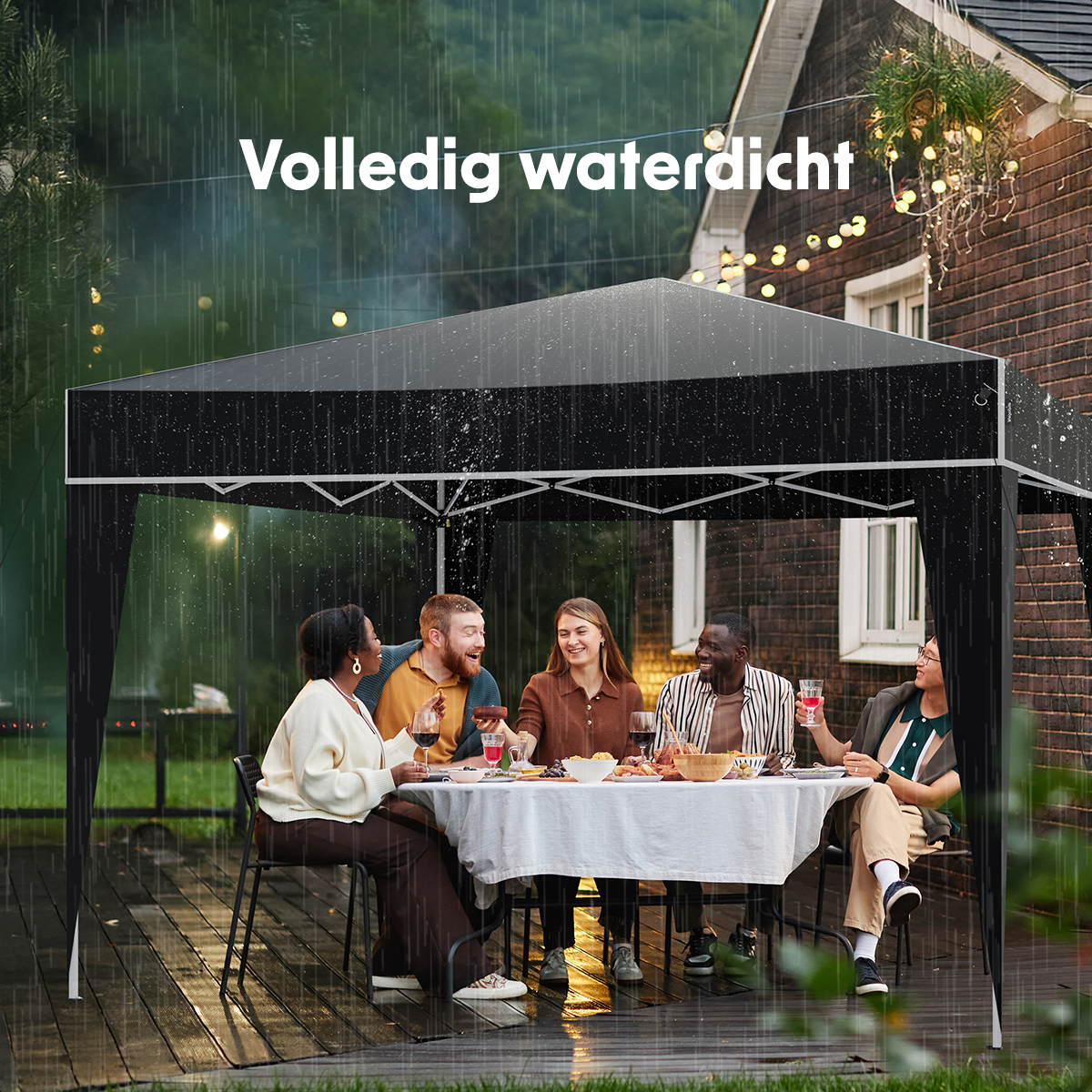 People dining at a table under a black tent in the rain. A house is in the background.
