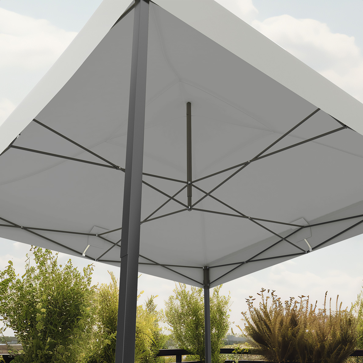 View from below of a white canopy tent with a black frame. Green bushes and blue sky in background.
