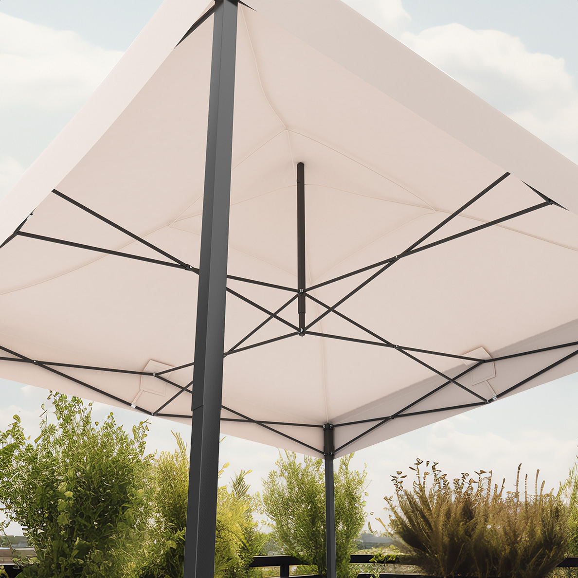 Cream-colored outdoor umbrella with black frame. Green bushes in the background. Sky in the backdrop.