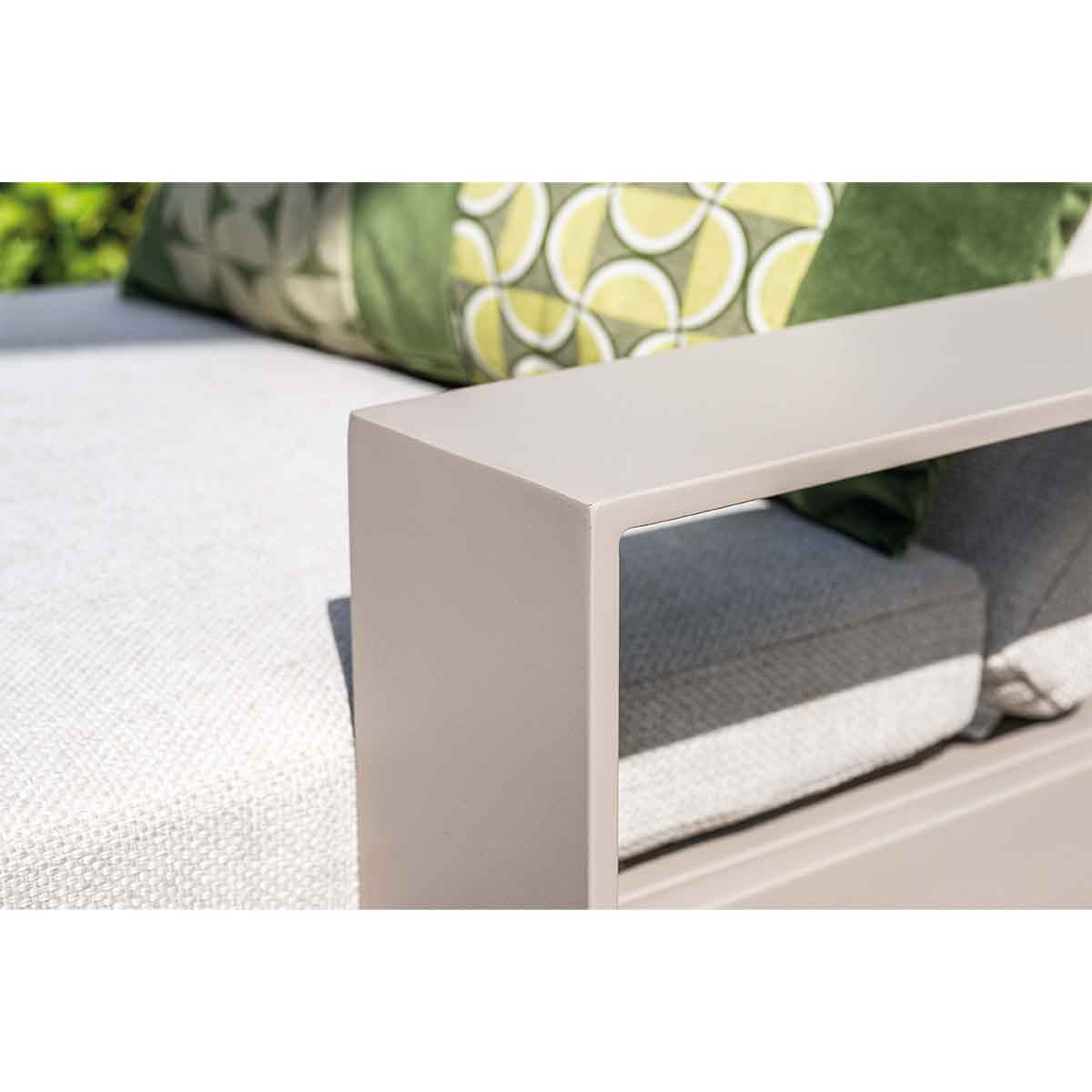 Close-up of a light-colored outdoor furniture set, with cushions.
