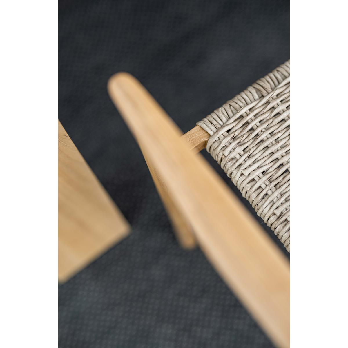 Close-up of a wooden chair's frame and woven backrest.