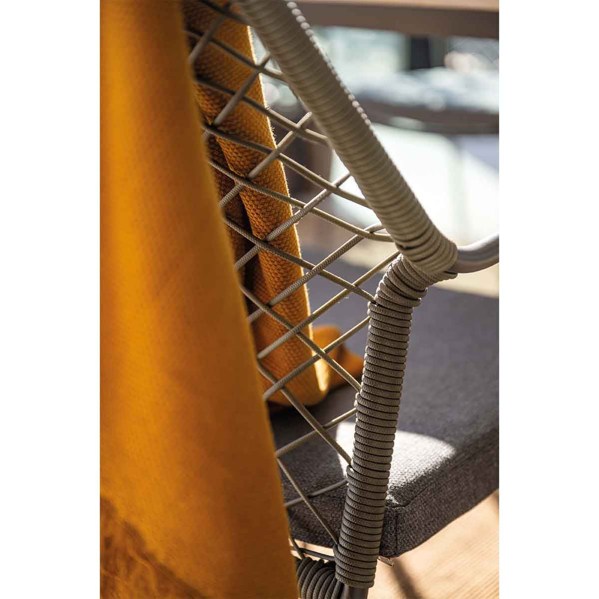 A yellow towel draped over a gray chair's back.