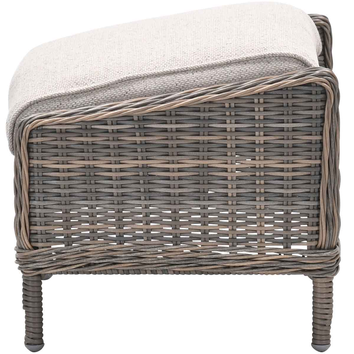 A gray wicker ottoman with a light beige cushion. The ottoman has a rectangular shape.