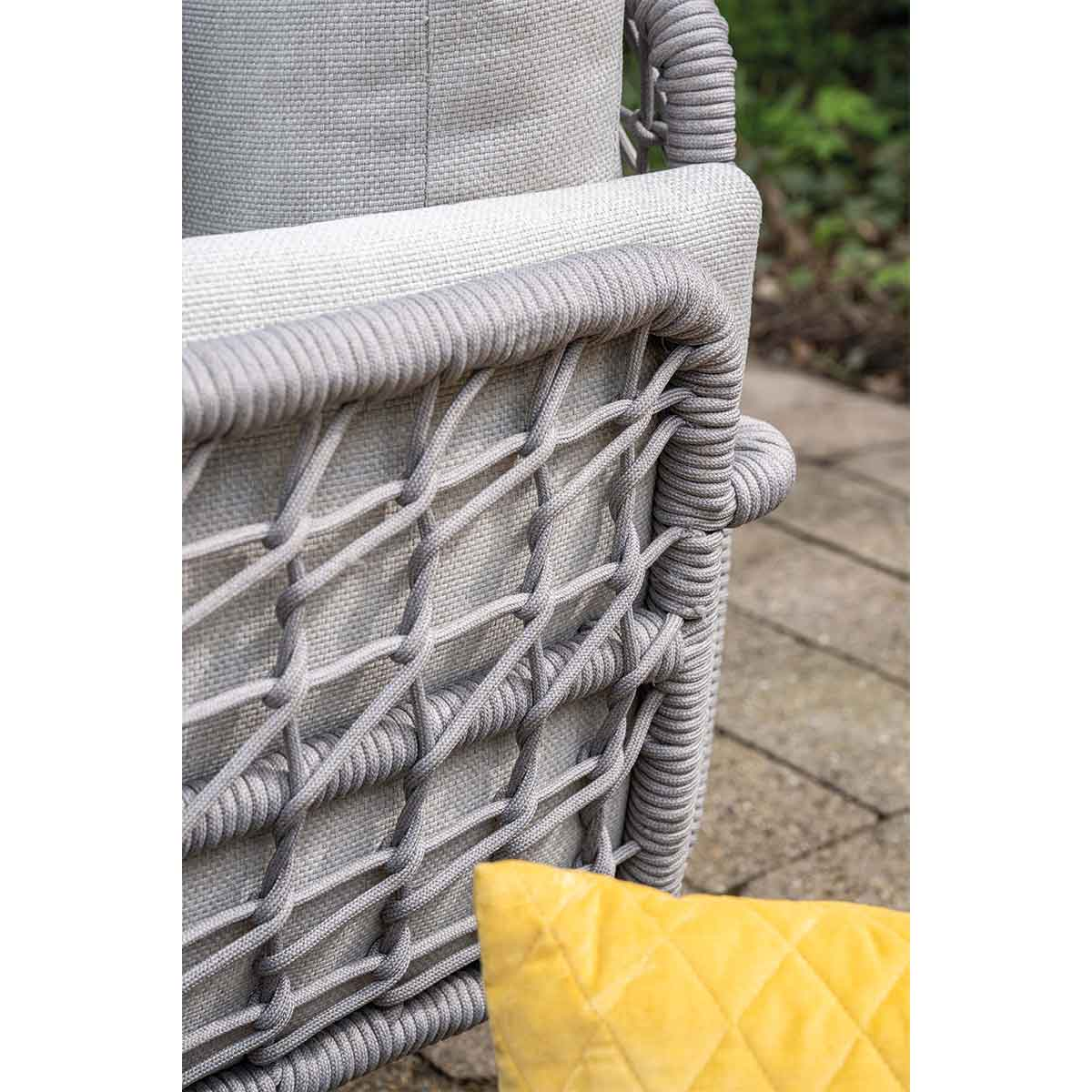 Close-up of a gray outdoor sofa with rope detailing on the back.