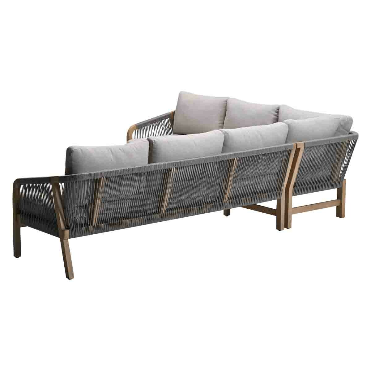 Gray sofa with wooden frame. Pillows on the back.