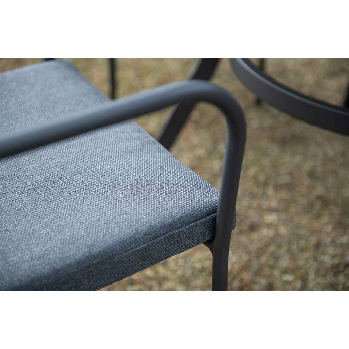Close up of a grey seat with a dark metal frame.