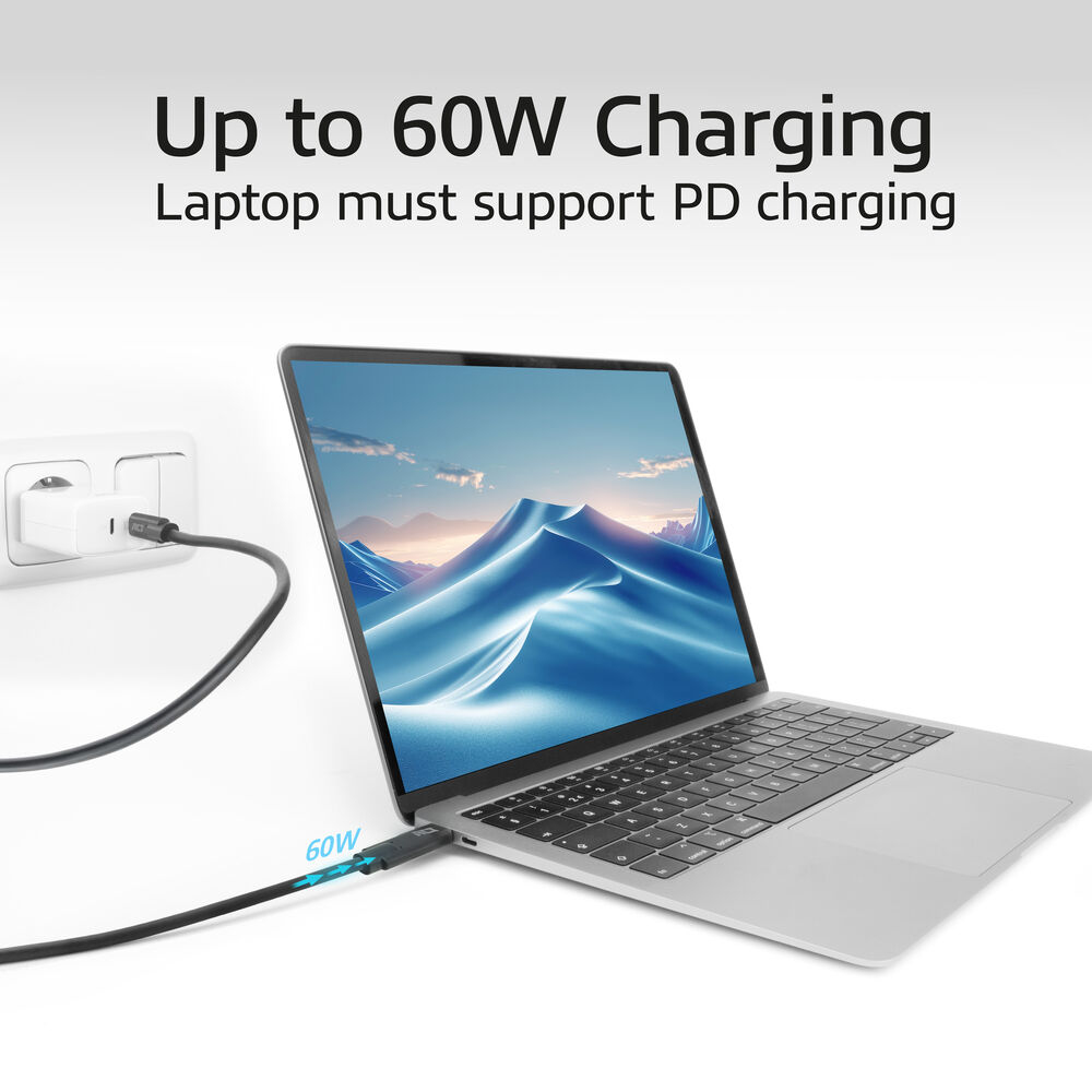 Laptop z niebieskim obrazem gór, podłączonym kablem ładującym i tekstem 'Up to 60W Charging'.
