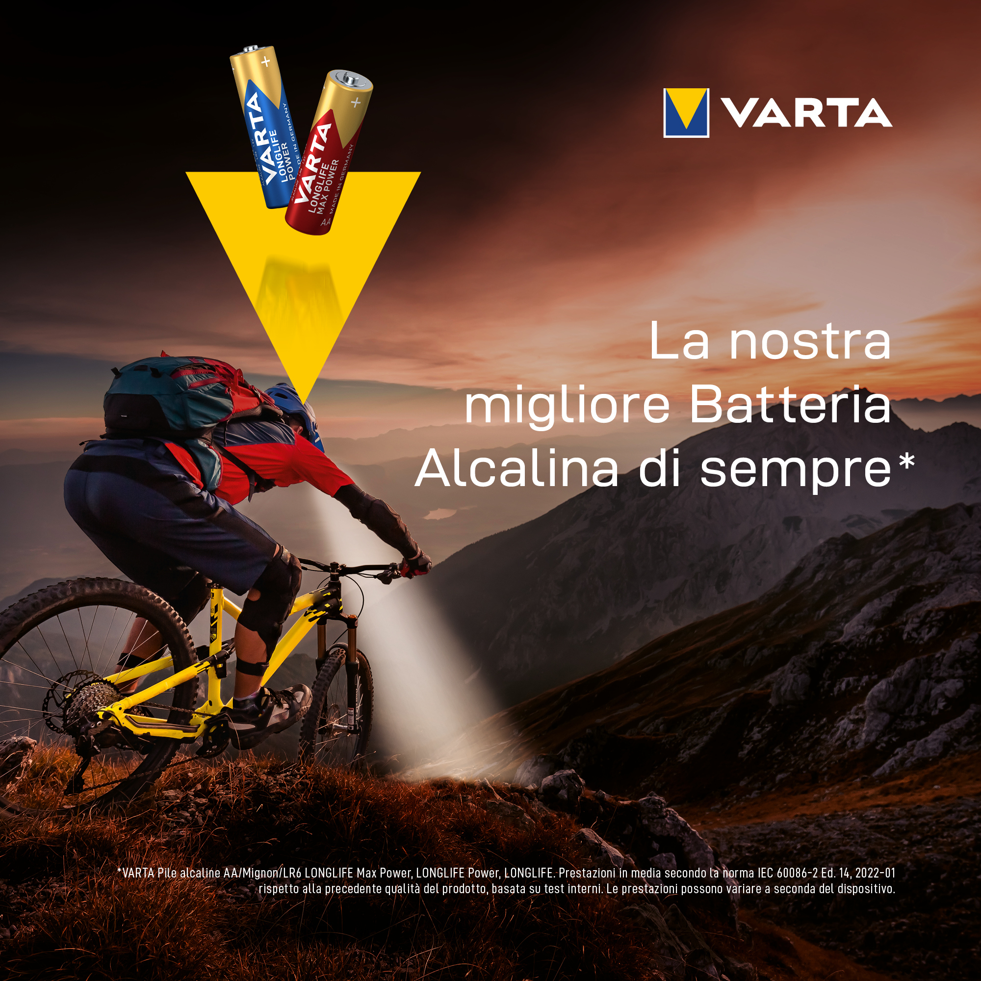 A mountain biker on a mountain, with a yellow bike, VARTA battery ad.