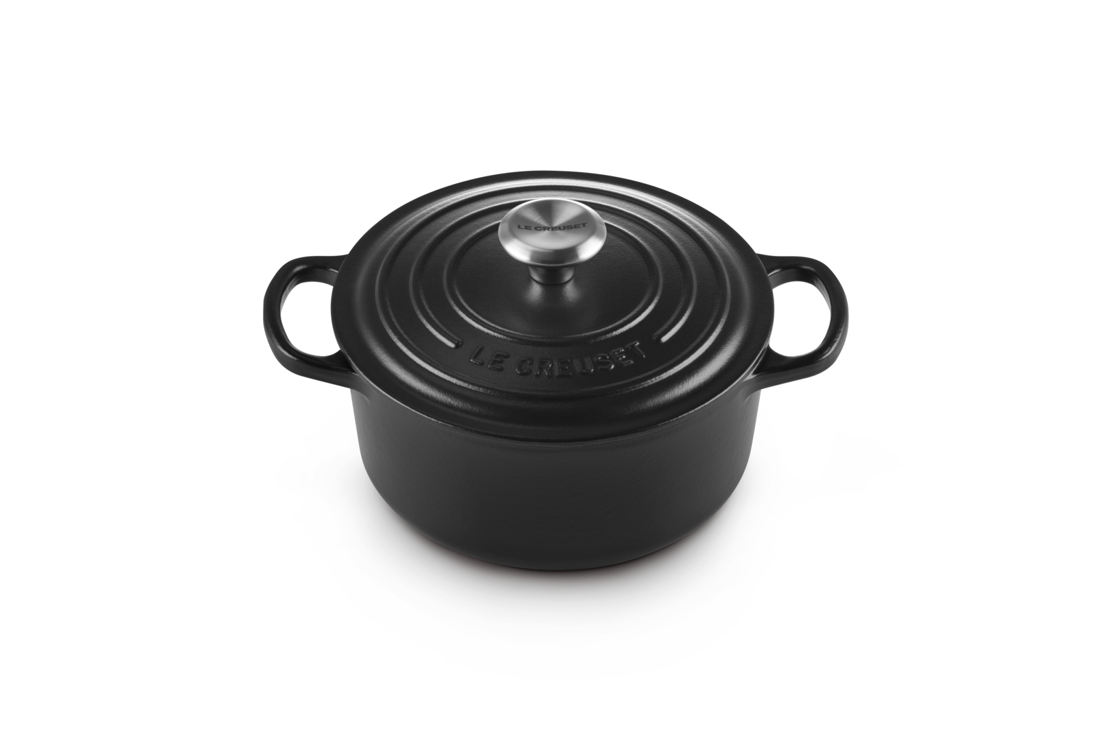 Black Le Creuset pot with lid on white background. Handles and knob are visible.