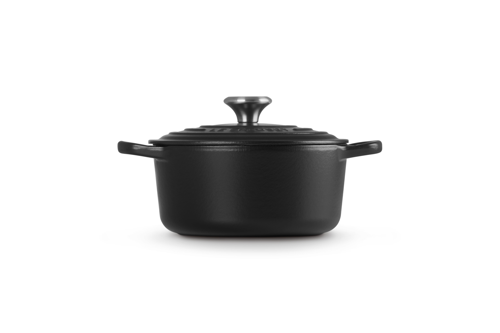 Black Le Creuset pot with lid on white background. Handles and knob are visible.