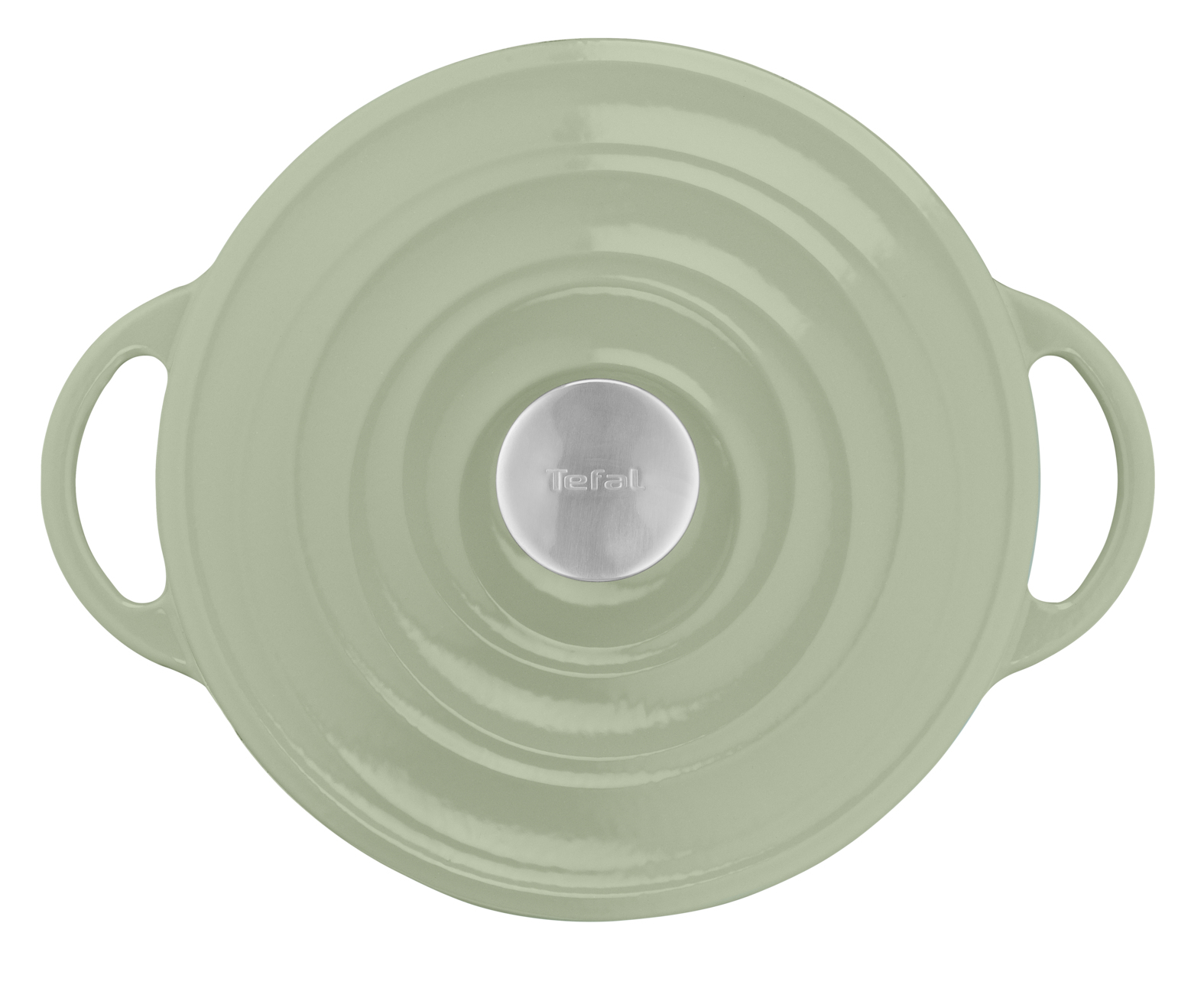Zielona pokrywka z srebrnym uchwytem, na białej powierzchni, z koncentrycznymi rowkami.
