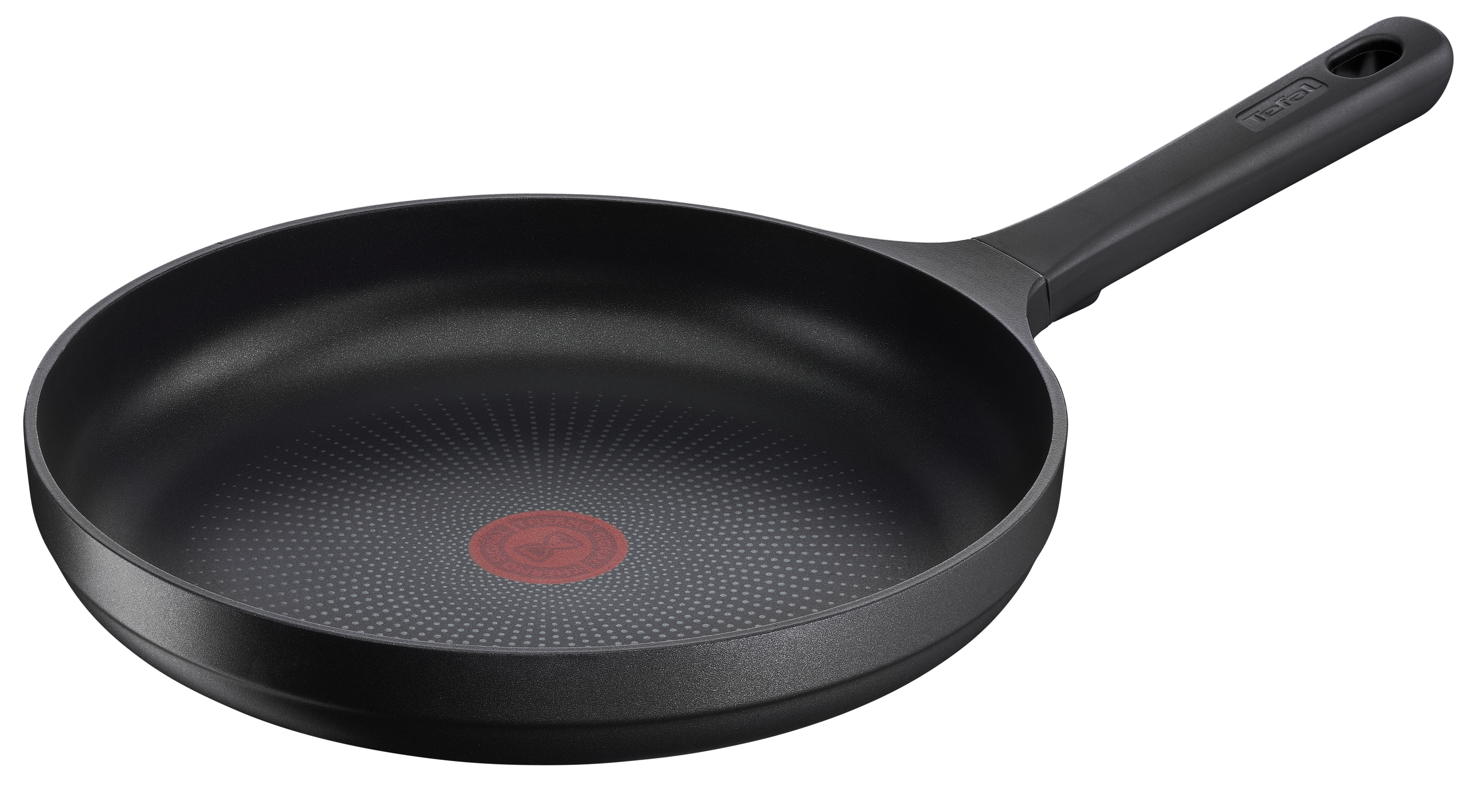 Czarna patelnia z czarnym uchwytem. Wnętrze ma teksturowaną powierzchnię z czerwonym kołem pośrodku.