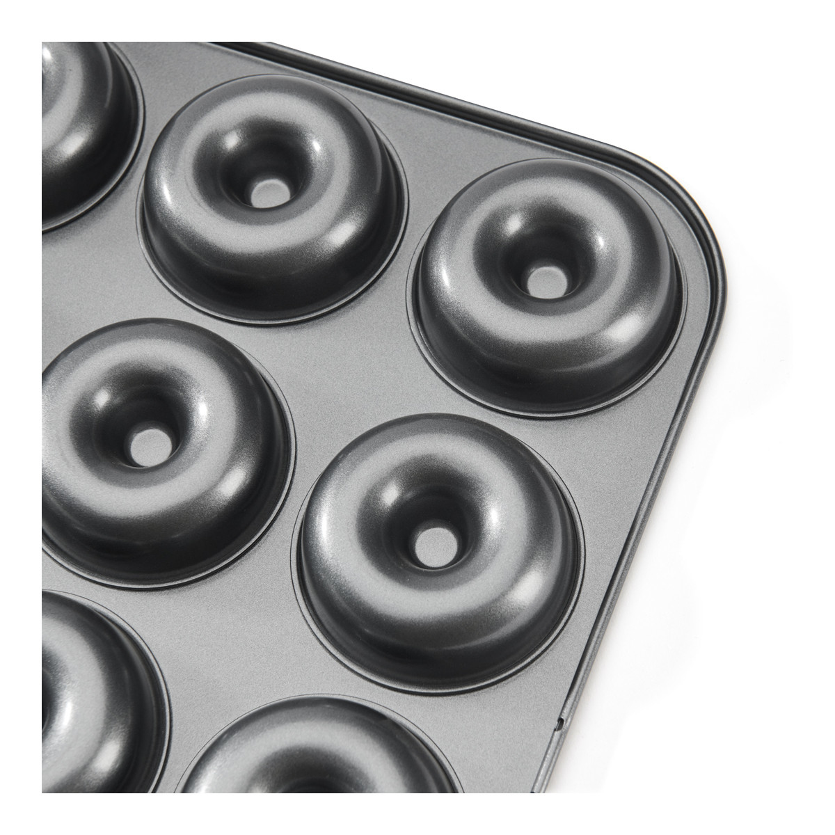 Eine Donut-Backform mit 6 Donut-Formen. Die Pfanne ist grau.