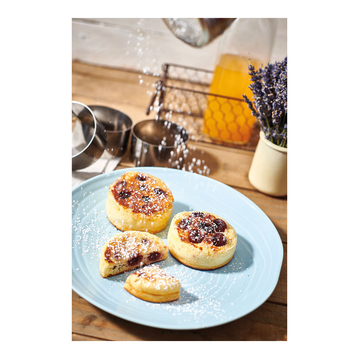 Gâteaux aux cerises sur une assiette bleue. Saupoudrage de sucre glace avec d'autres éléments.