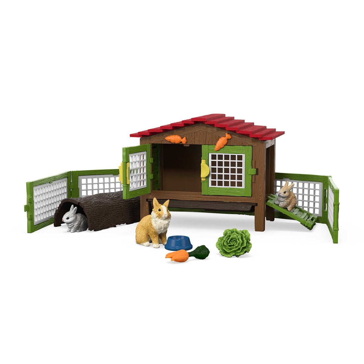 Spielzeug-Kaninchenstall mit Kaninchen, Karotten, einer Schüssel und Salat. Zwei Kaninchen sind im Haus.