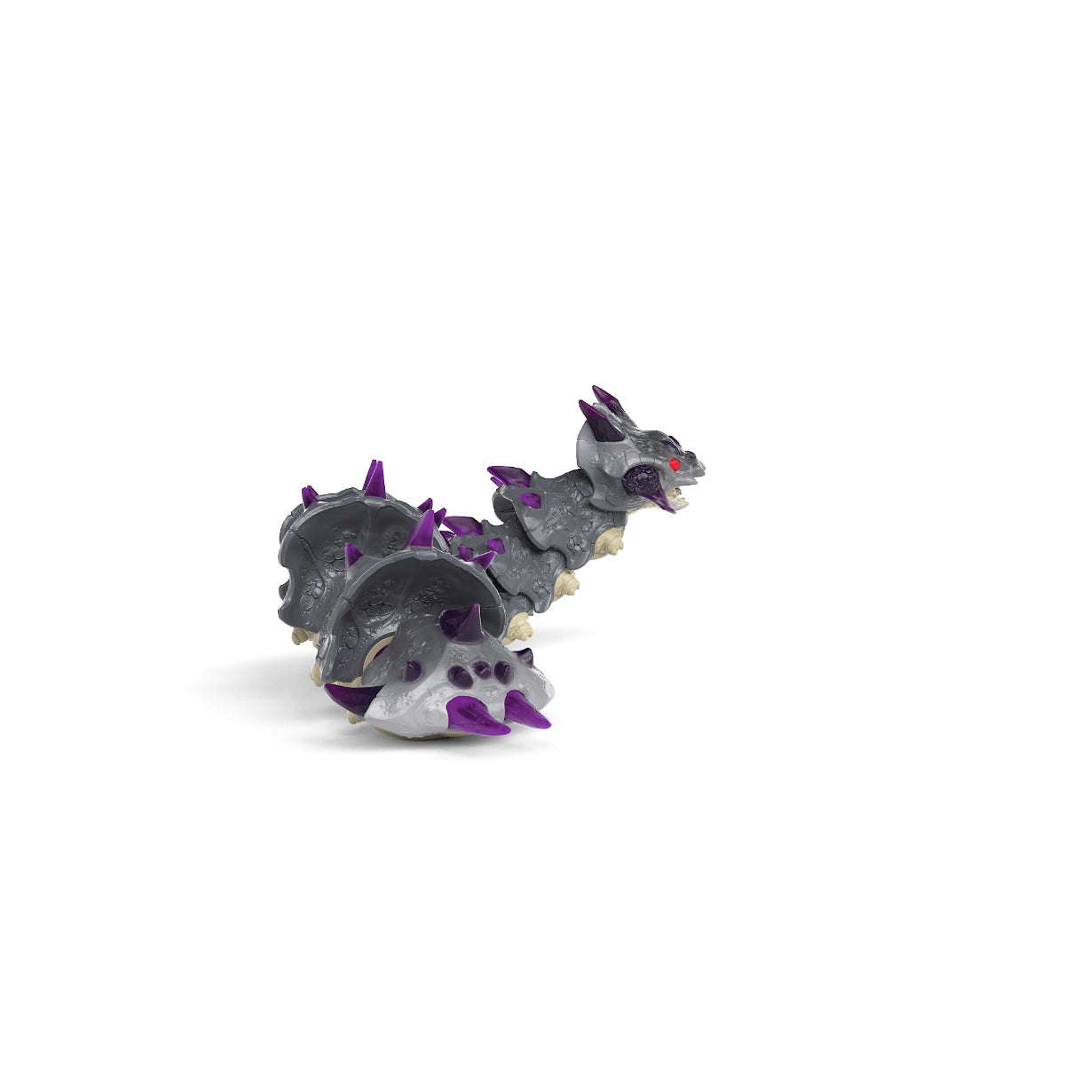 Figura de juguete de un dragón gris de varias cabezas con púas moradas, sobre blanco.