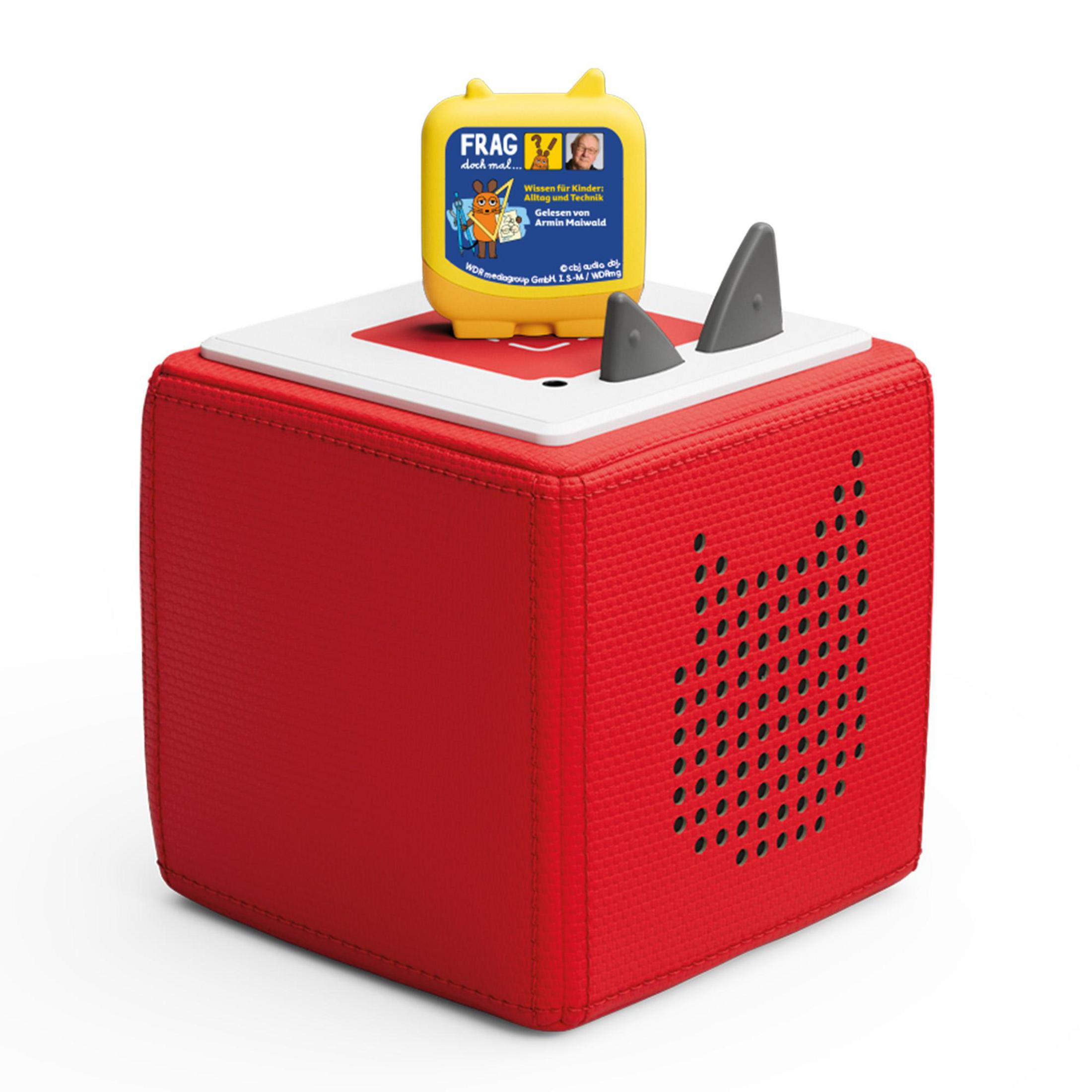 Czerwona i biała kostka z żółtą górą. Dwa szare płetwy rekina na górze. Tekst po niemiecku.