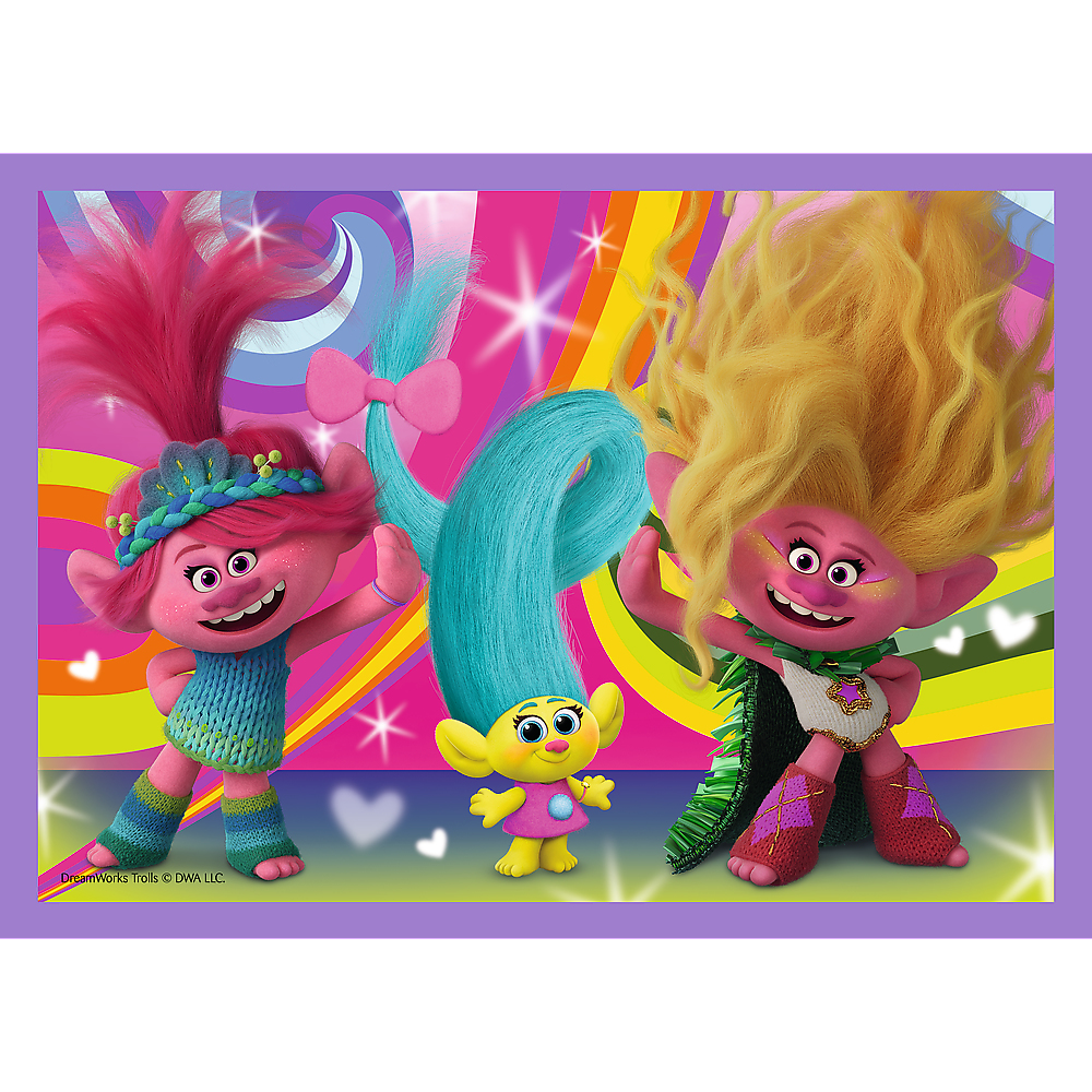 Three Trolls characters in a colorful scene. They are smiling and posing with colorful hair.