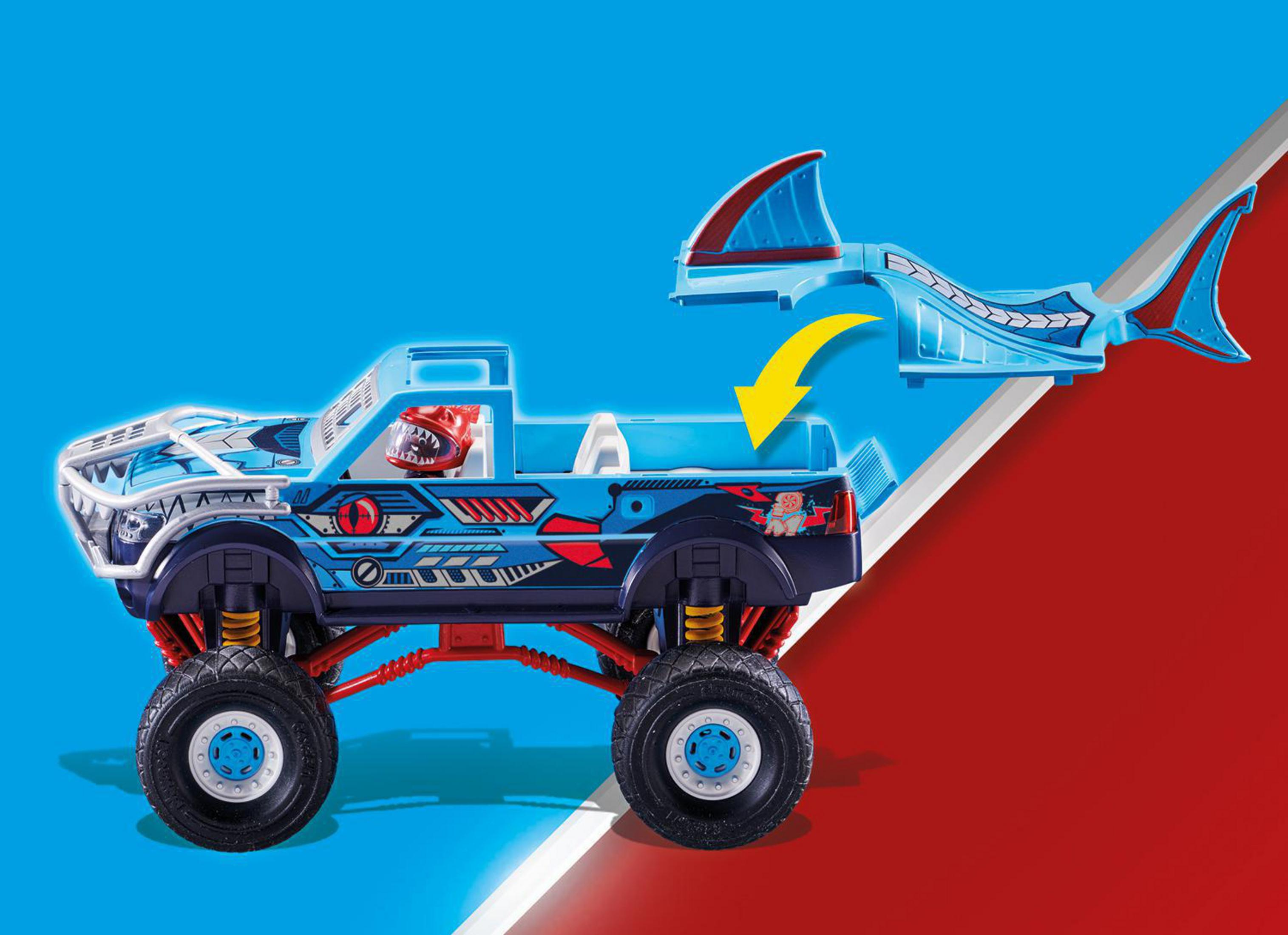 Camión monstruo Playmobil azul con diseño de aleta de tiburón, fondo rojo y azul.