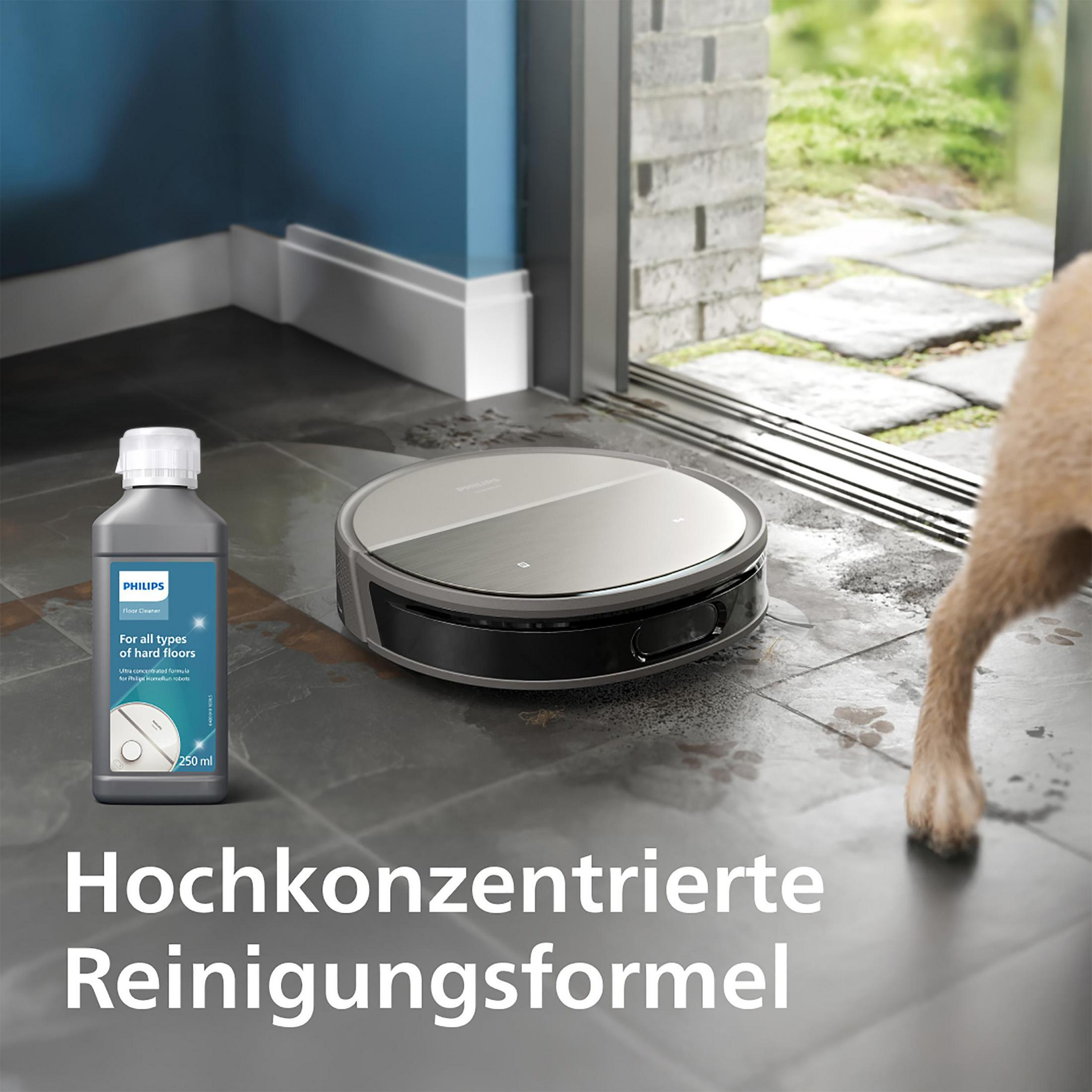 Butelka płynu do mycia podłóg Philips obok robota sprzątającego Philips HomeRun i psa.