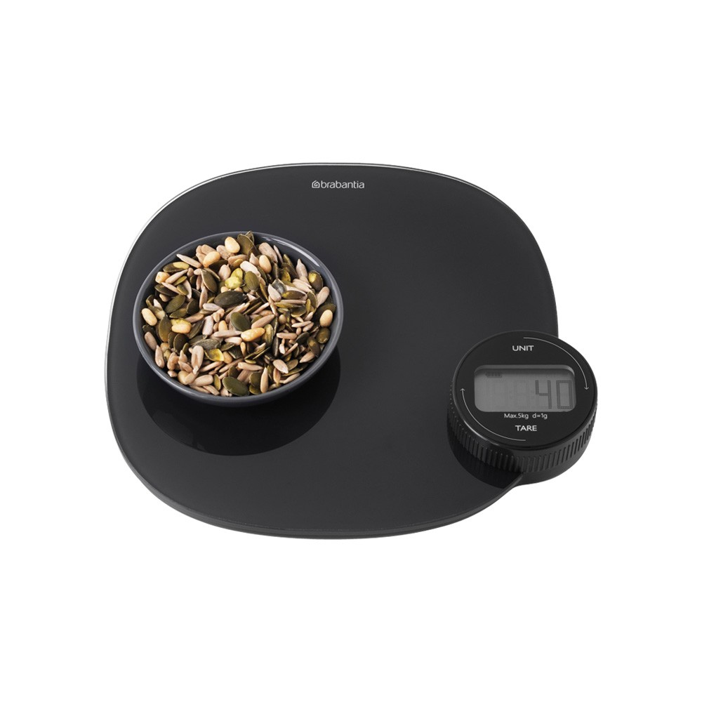 Czarna waga cyfrowa z nasionami w misce. Waga pokazuje '4.0'. Białe tło.