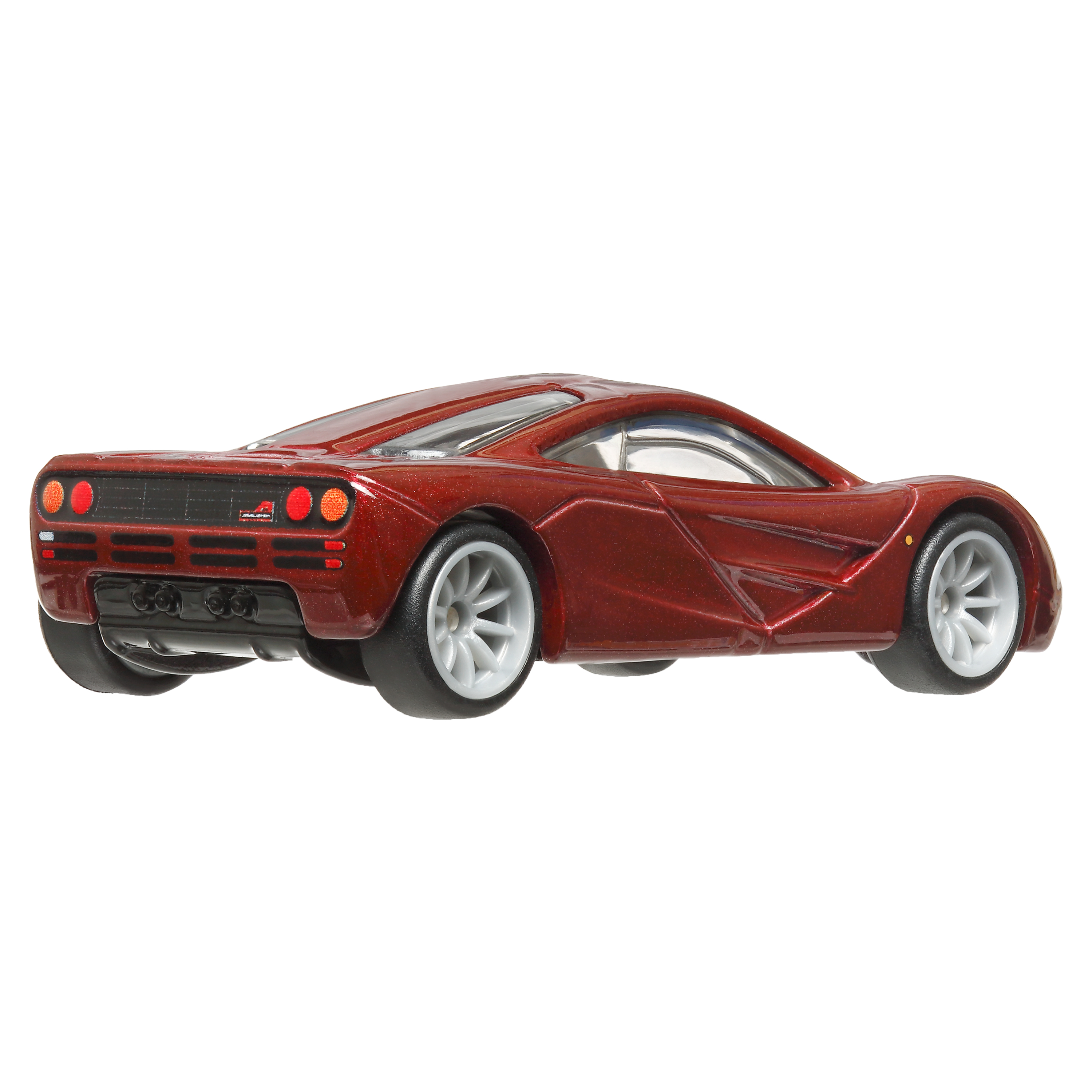 Ein rotes Spielzeugauto, ein McLaren F1, wird von hinten gezeigt.