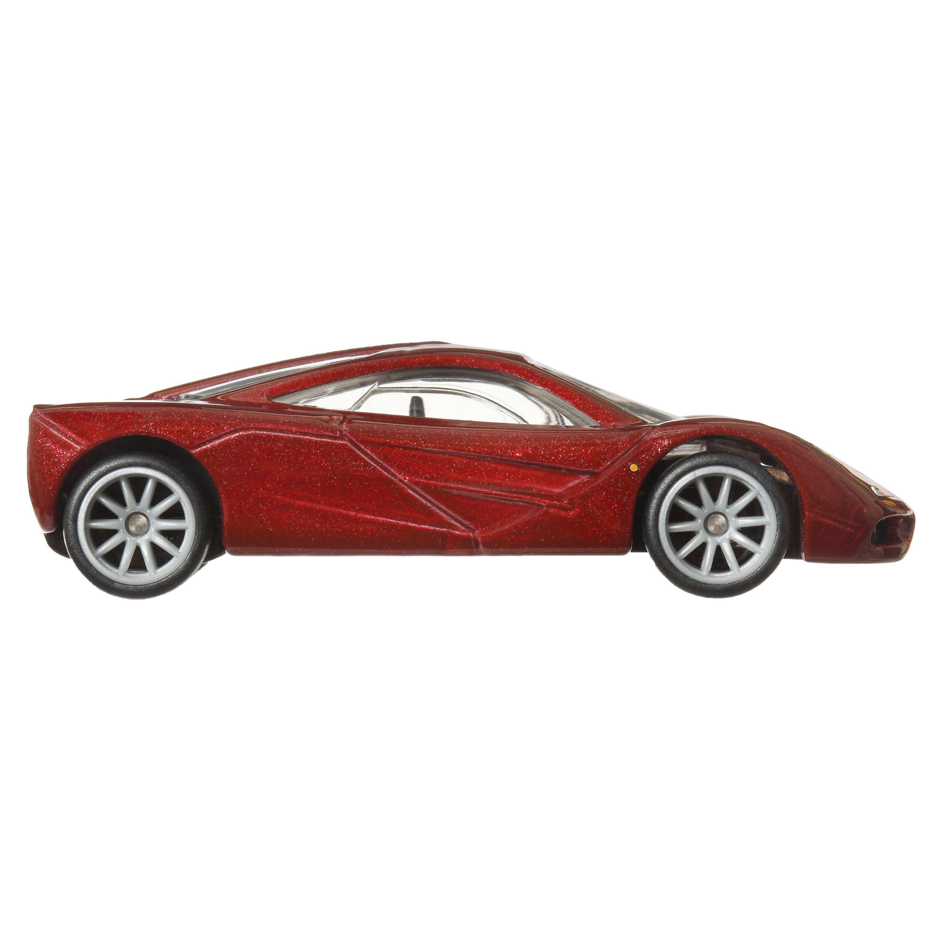 Rotes, glitzerndes McLaren F1 Spielzeugauto, Seitenansicht, auf weißem Hintergrund.