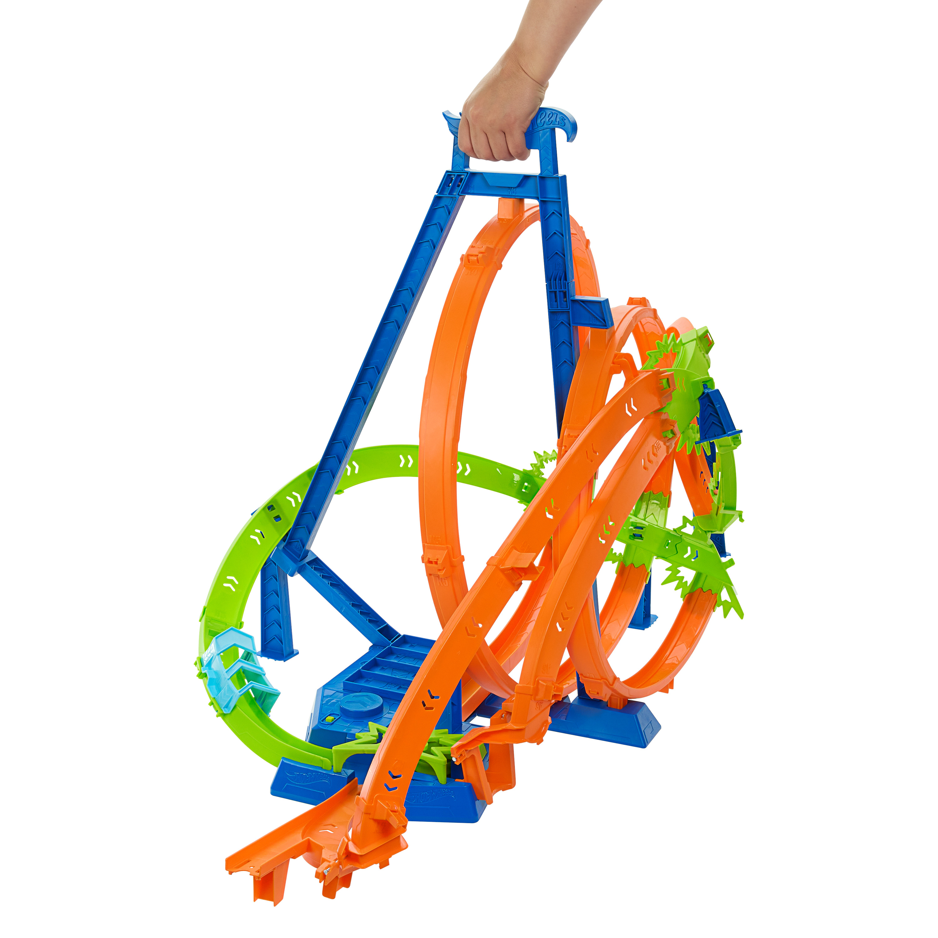 Zestaw torów Hot Wheels. Niebieskie i pomarańczowe pętle, ręka trzymająca tor.