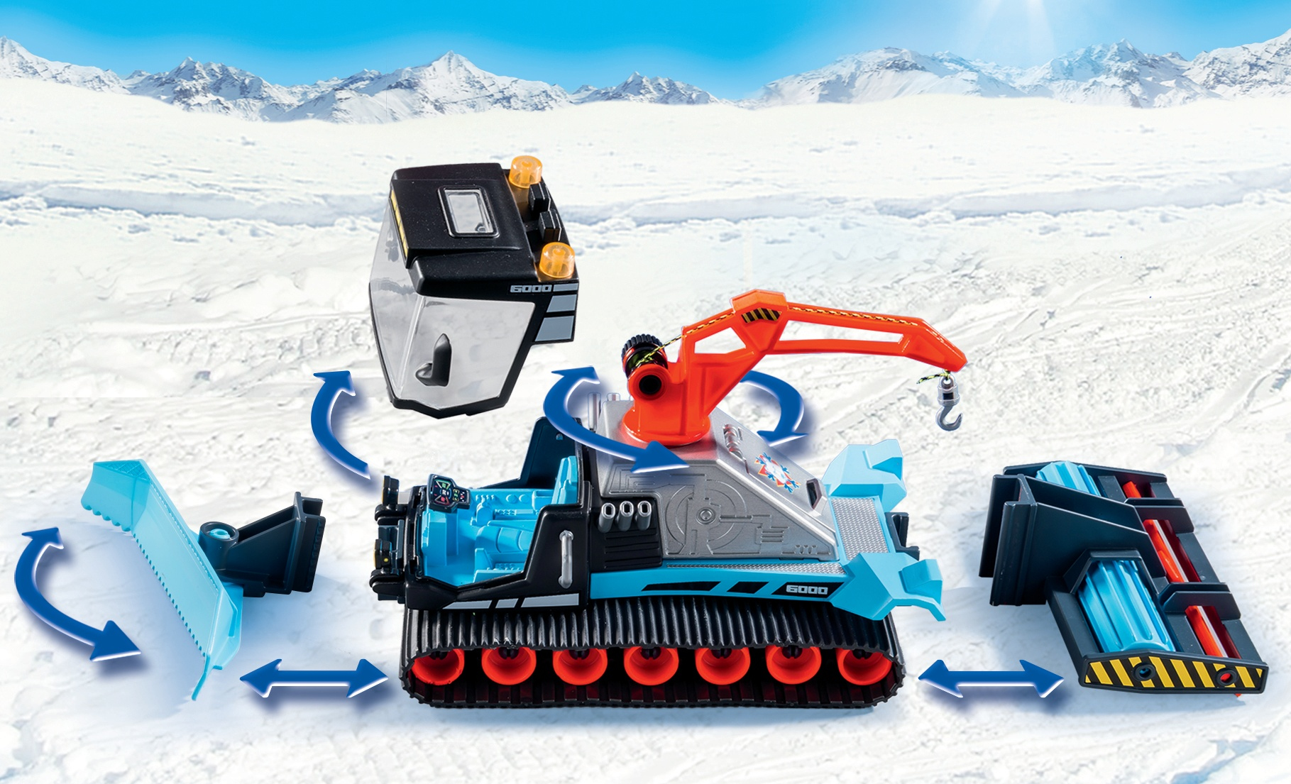 Zabawkowy ratrak z odłączanymi częściami. Kolory niebieski i pomarańczowy dominują na tle śnieżnym.