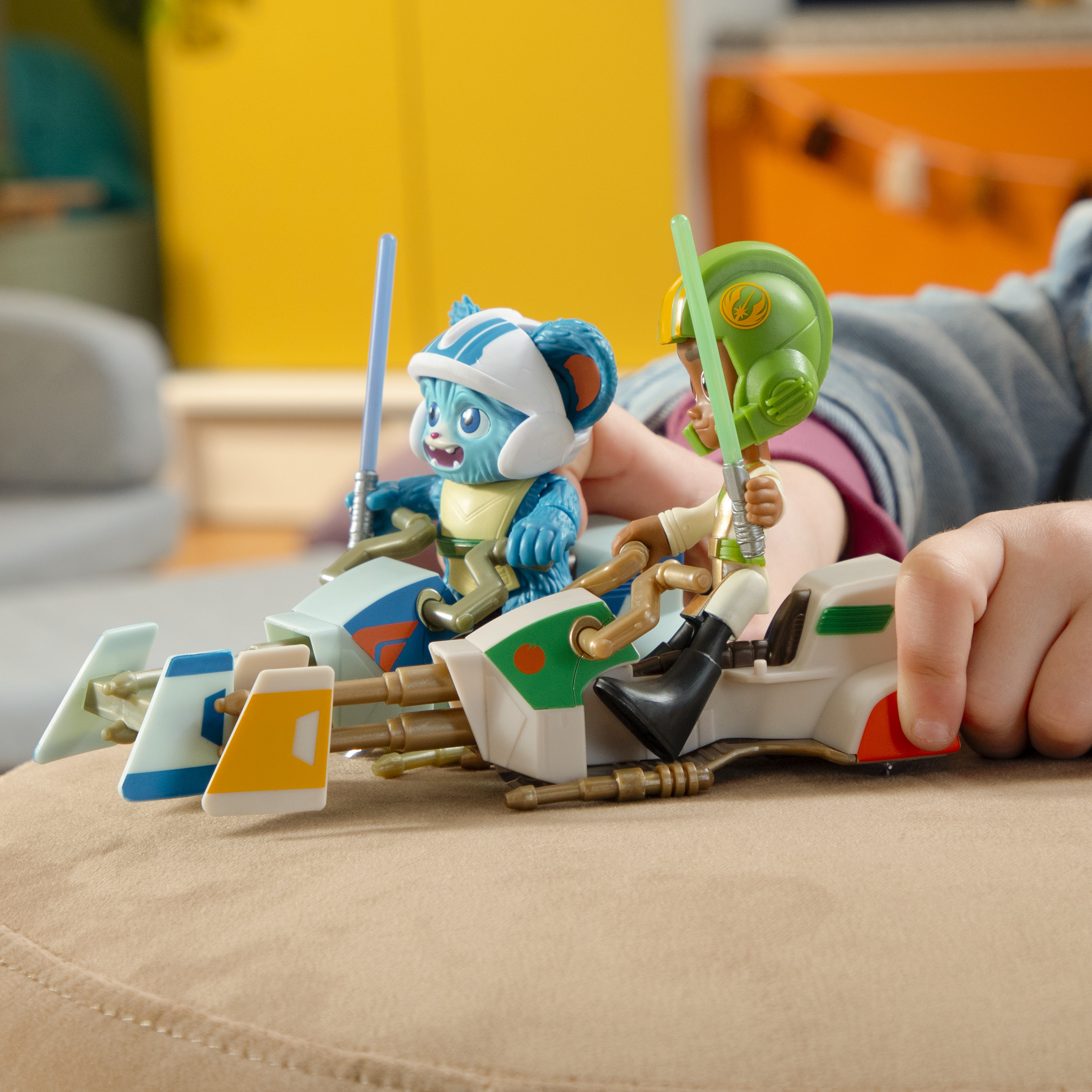 Dwa zabawki z motywem Gwiezdnych Wojen. Jeden niebieski, jeden zielony, każdy z figurką.