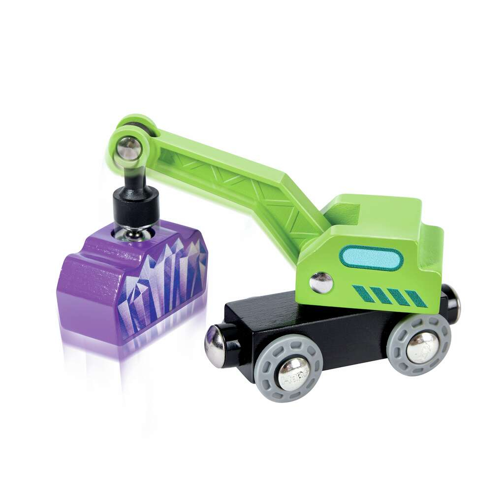 Zielony i fioletowy dźwig zabawkowy podnosi fioletową skałę. Czarna podstawa, szare koła.