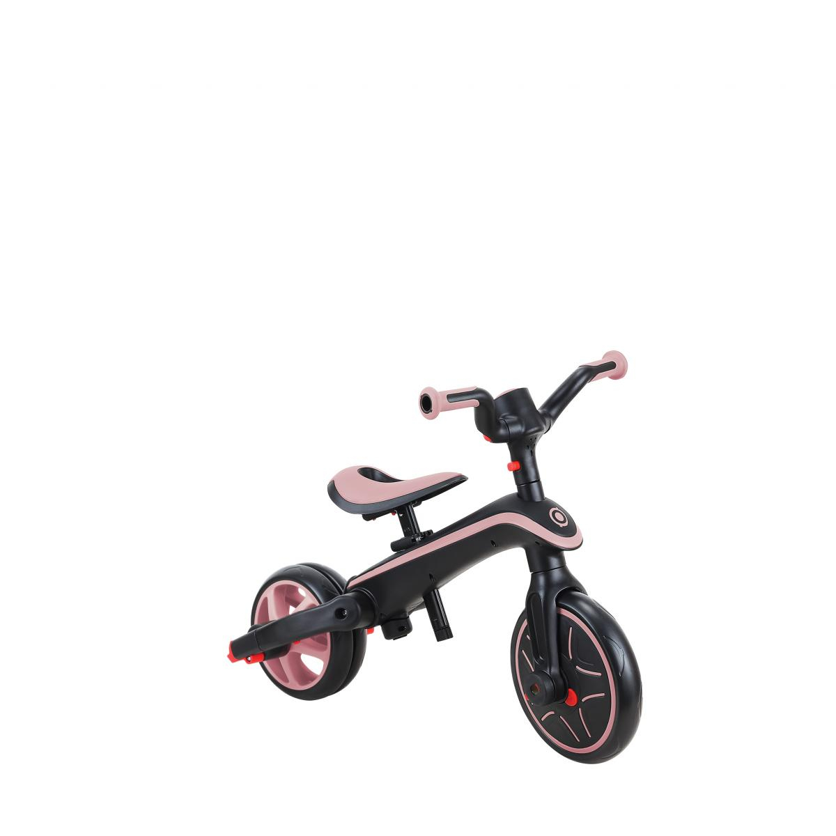 Bicicletta senza pedali nera e rosa per bambini, su sfondo bianco.