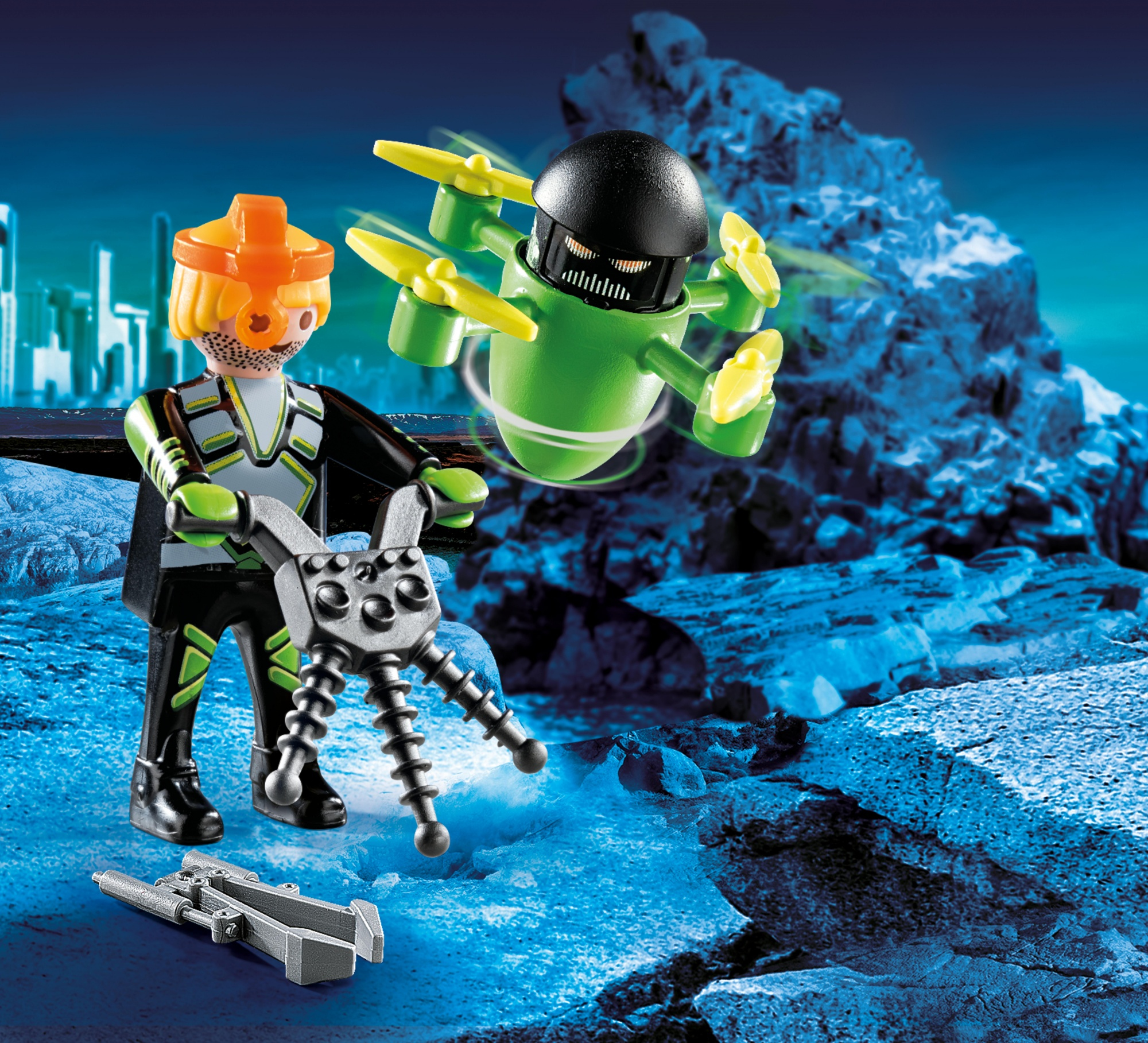 Due personaggi Playmobil con una pistola e un drone su sfondo roccioso.