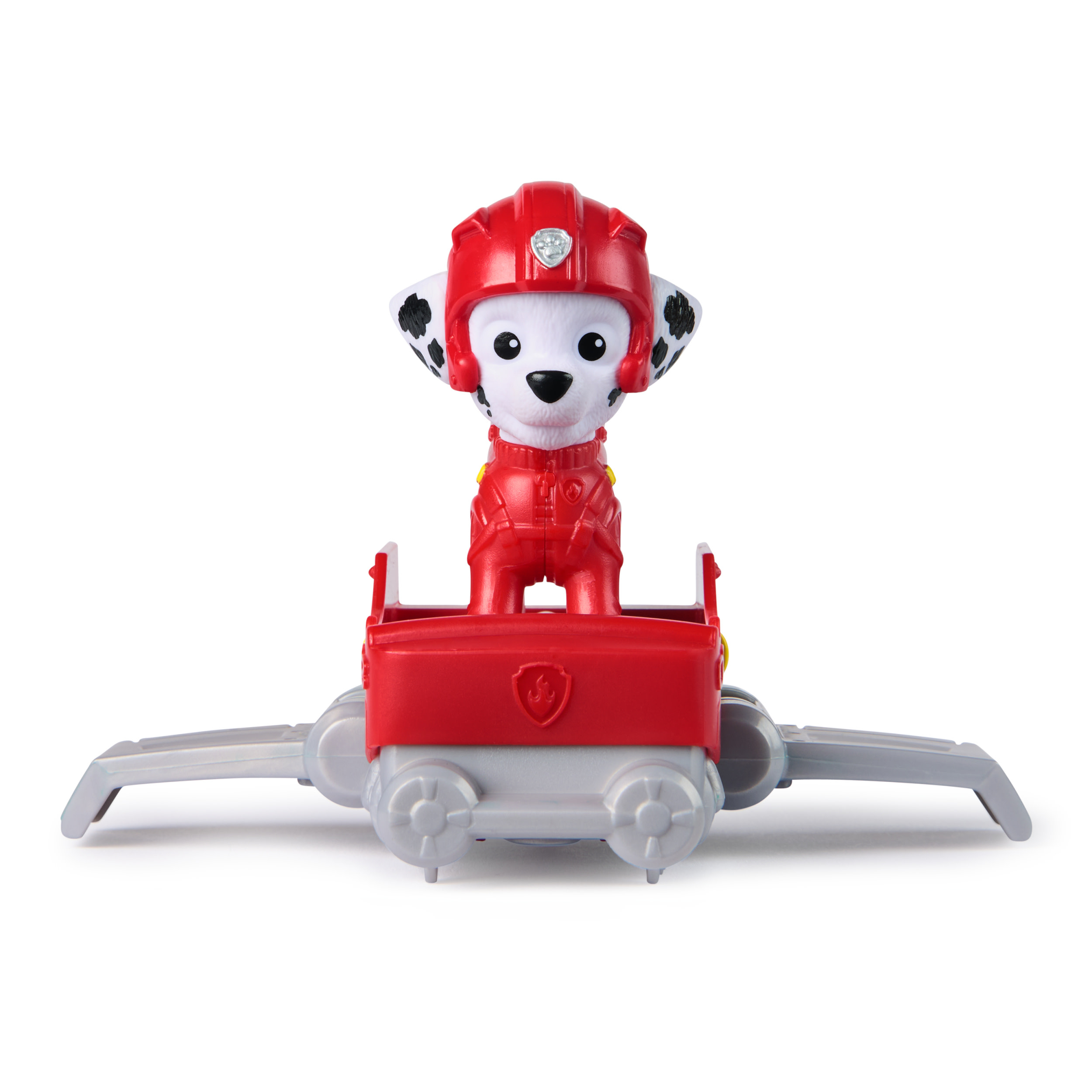 Eine Paw Patrol Spielfigur in roter Uniform, stehend in einem roten Fahrzeug mit Flügeln. Die Figur trägt einen Helm.