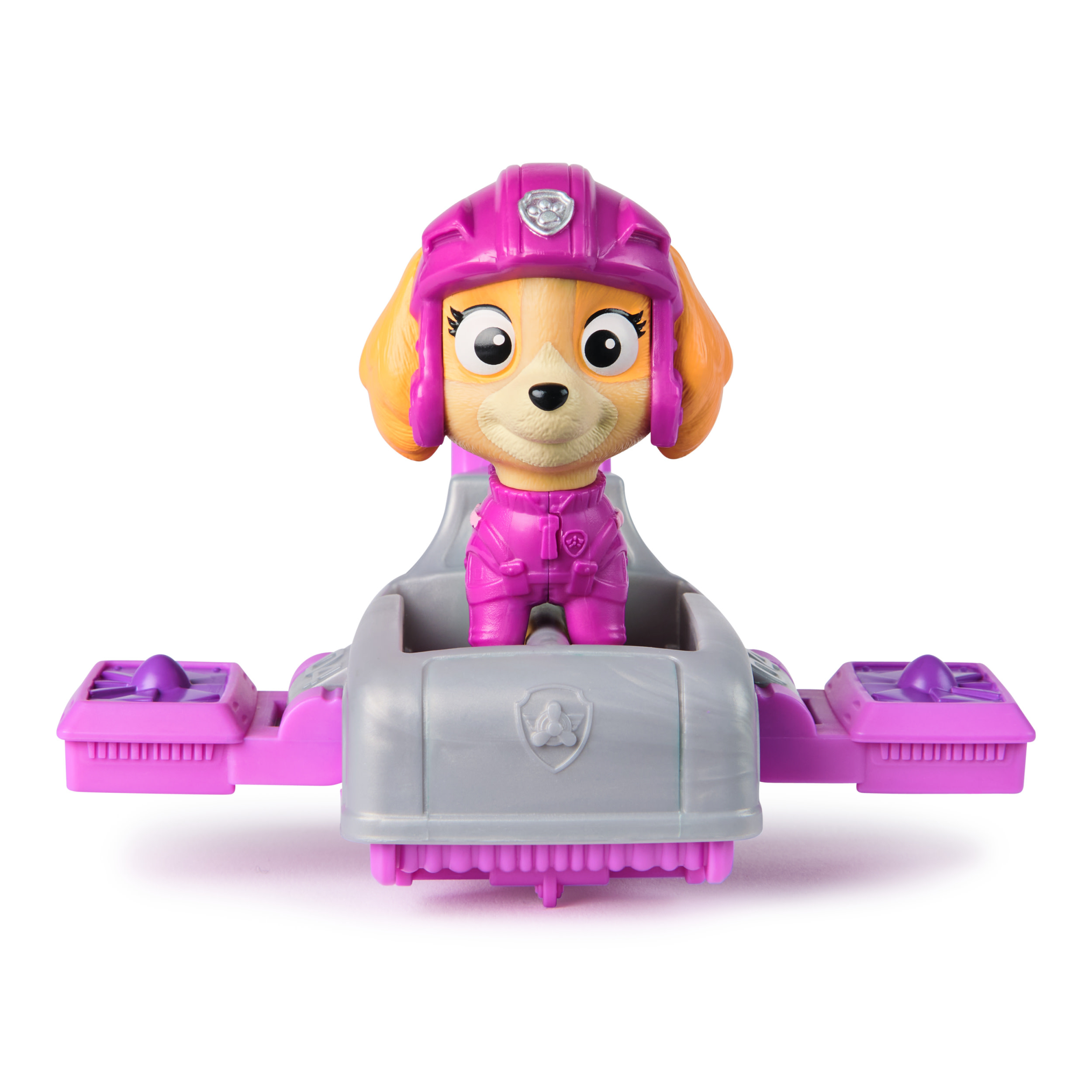 Paw Patrol Skye Spielzeug in einem rosa-grauen Fahrzeug. Das Spielzeug ist auf weißem Hintergrund.