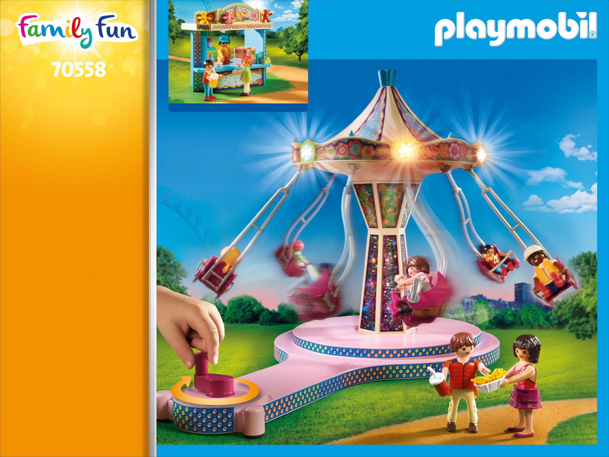 Set de parque de atracciones Playmobil con tiovivo y figuras. Una mano gira una rueda.
