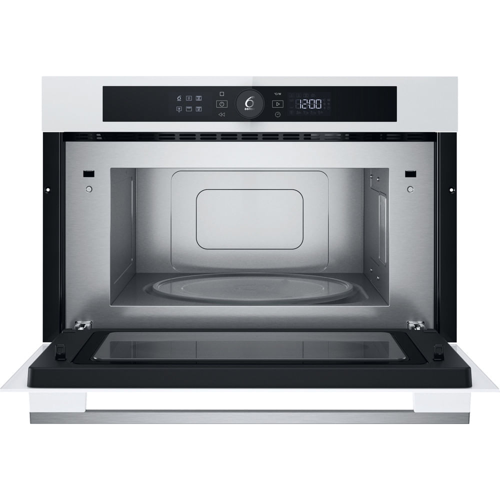 Forno a microonde aperto con porta in vetro che mostra l'interno, la cornice bianca e il display digitale.