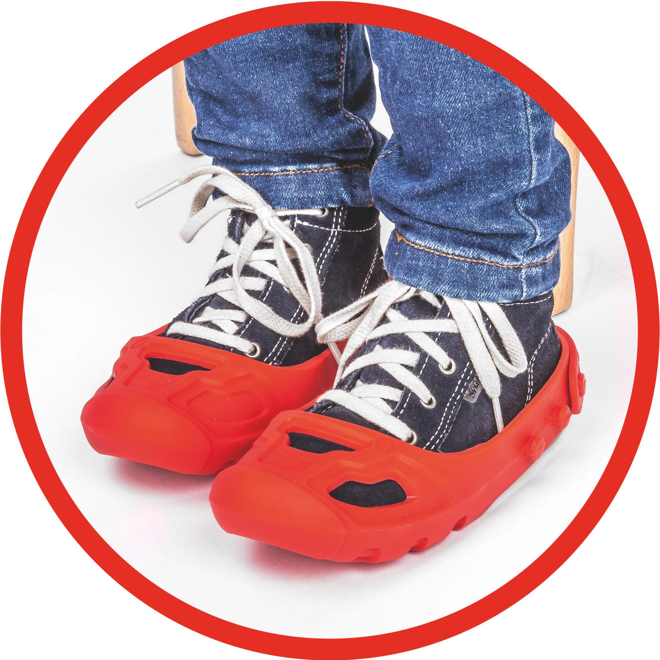 Czerwone osłony na buty na niebieskich tenisówkach na stopach dziecka, w czerwonym okręgu.