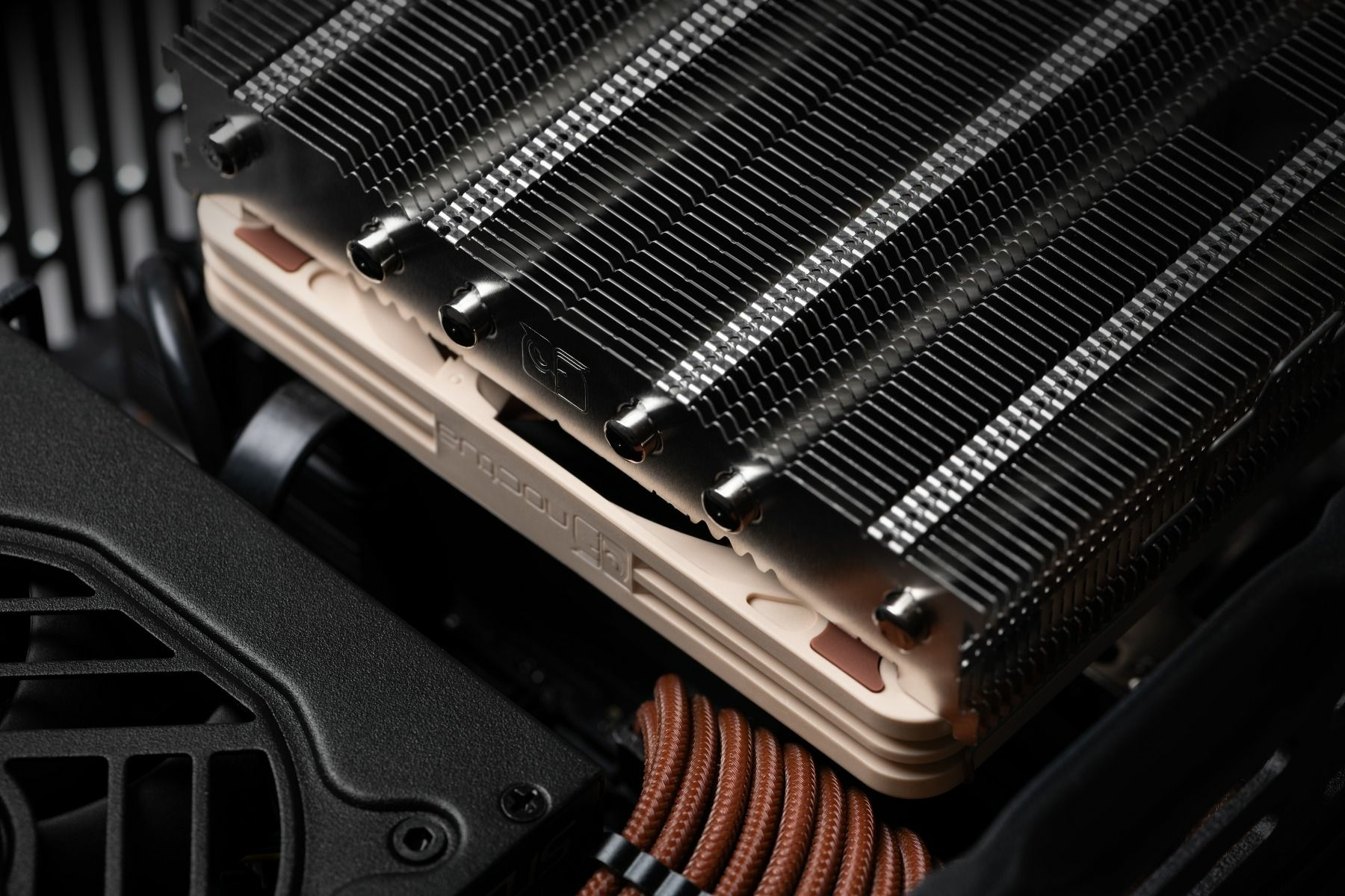 Noctua CPU cooler installed in a computer case. The cooler is silver and brown.