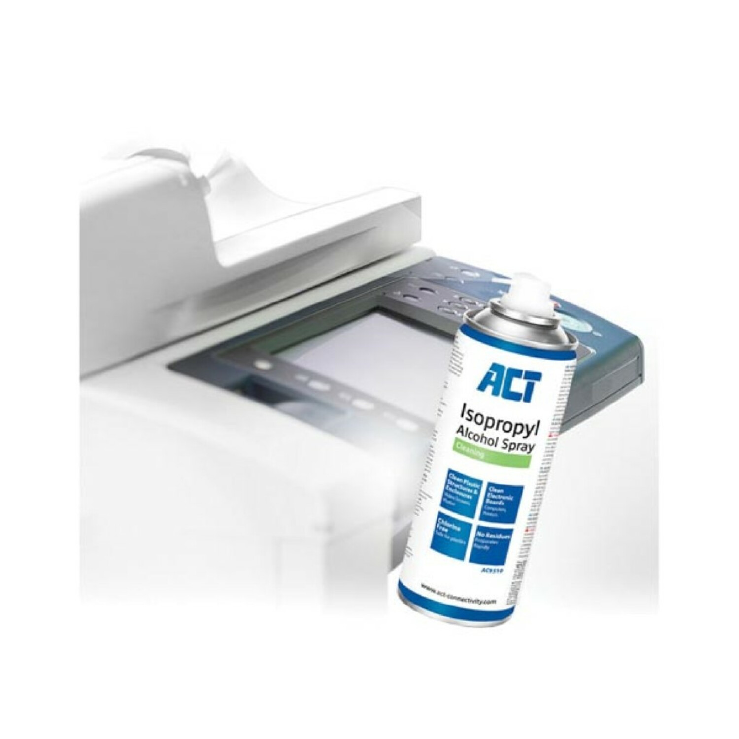 Butelka ze sprayem izopropylowym obok kserokopiarki. Kserokopiarka jest biała.